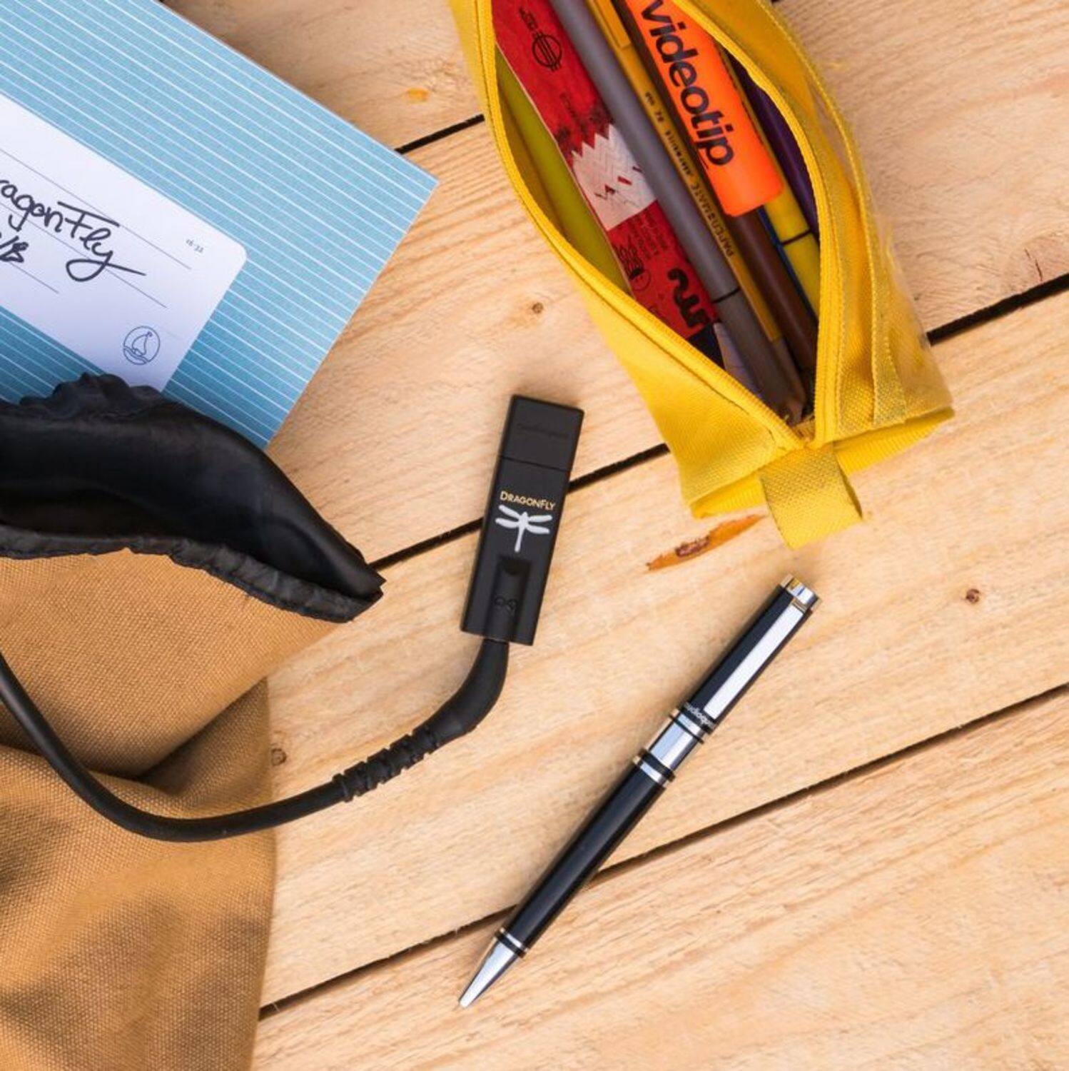 The text on the image is:

- "agontly VB"
- "videotip"
- "PAPEDAMALE"
- "DRAGONFLY"
- "CS"

Grouping and correcting the text:

- "agontly VB" (appears on the envelope)
- "videotip" (appears on the pen)
- "PAPEDAMALE" (appears on the pen)
- "DRAGONFLY" (appears on the pen)
- "CS" (appears on the pen)