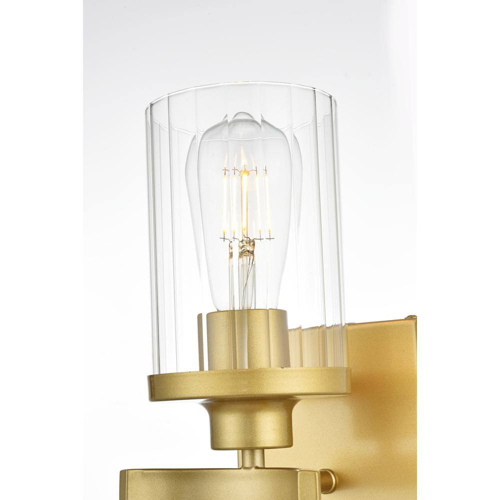 Left. Living District - Saanvi 1 light Brass and Clear Bath Sconce - Brass And Clear.