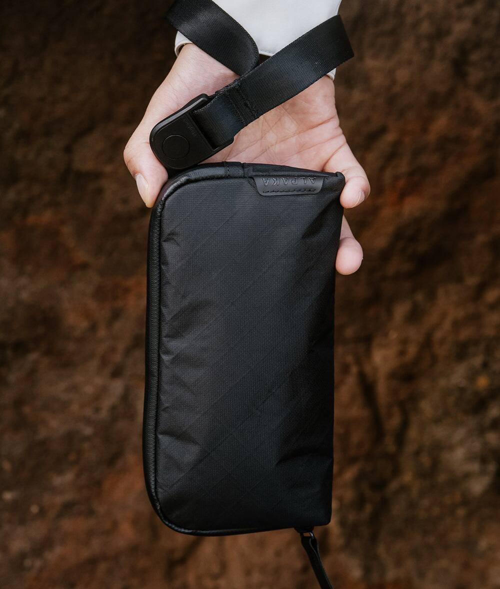 Left. ALPAKA - Flight Pouch Travel Clutch Phone Bag, Passport Holder, Crossbody Pouch, Wristlet, YKK AquaGuard Zippers - Black Ultradyne 100D.