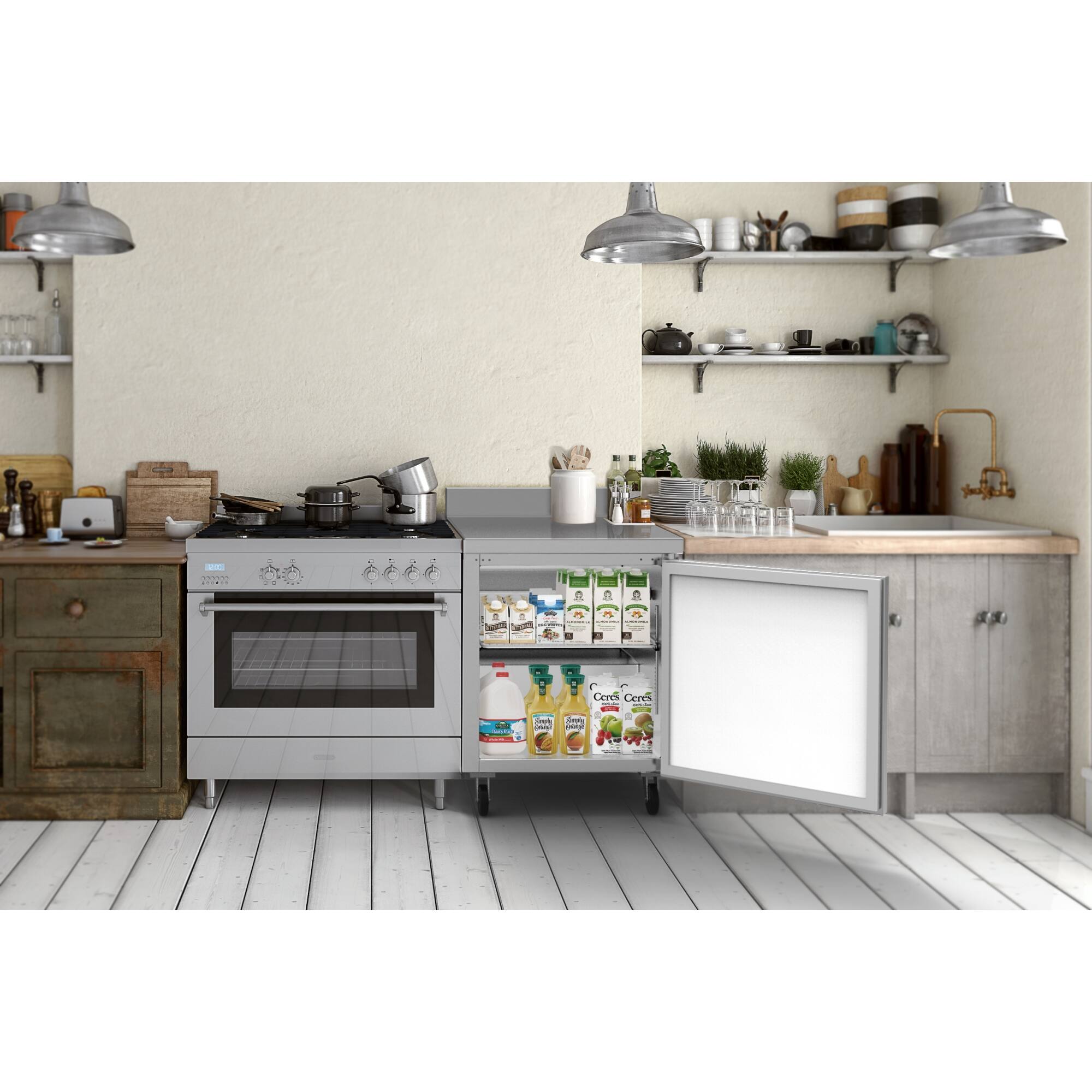 The image shows a kitchen with a stove top oven and a refrigerator. The kitchen is well-stocked with various items, including multiple bottles, cups, bowls, and a vase. There are also several knives and spoons placed around the kitchen. The kitchen features a large oven, which is likely a focal point of the space. The overall scene is well-organized and ready for cooking and meal preparation.