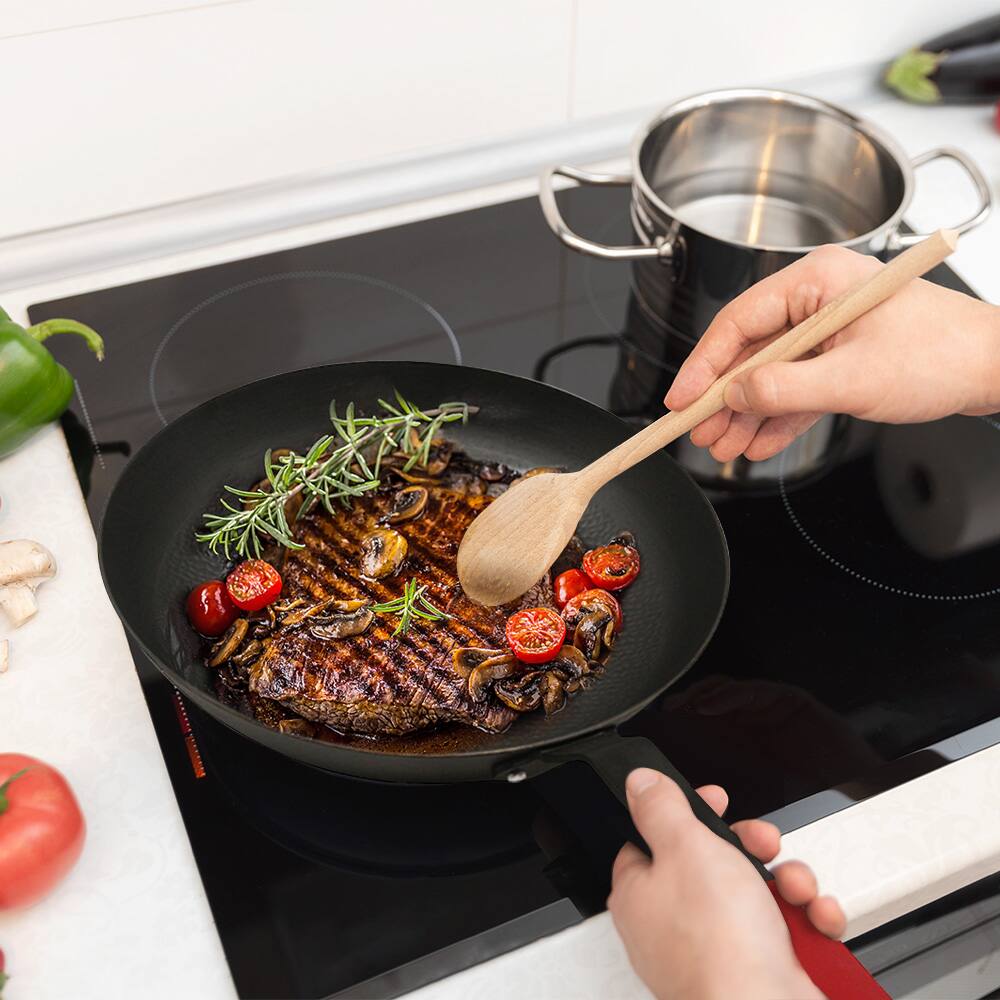 Angle. Hansmart - HANSMART Lightweight Cast Iron Skillet Pre-Seasoned 12 Inch Cooking Pan Indoor Outdoor Versatile Use - Black.