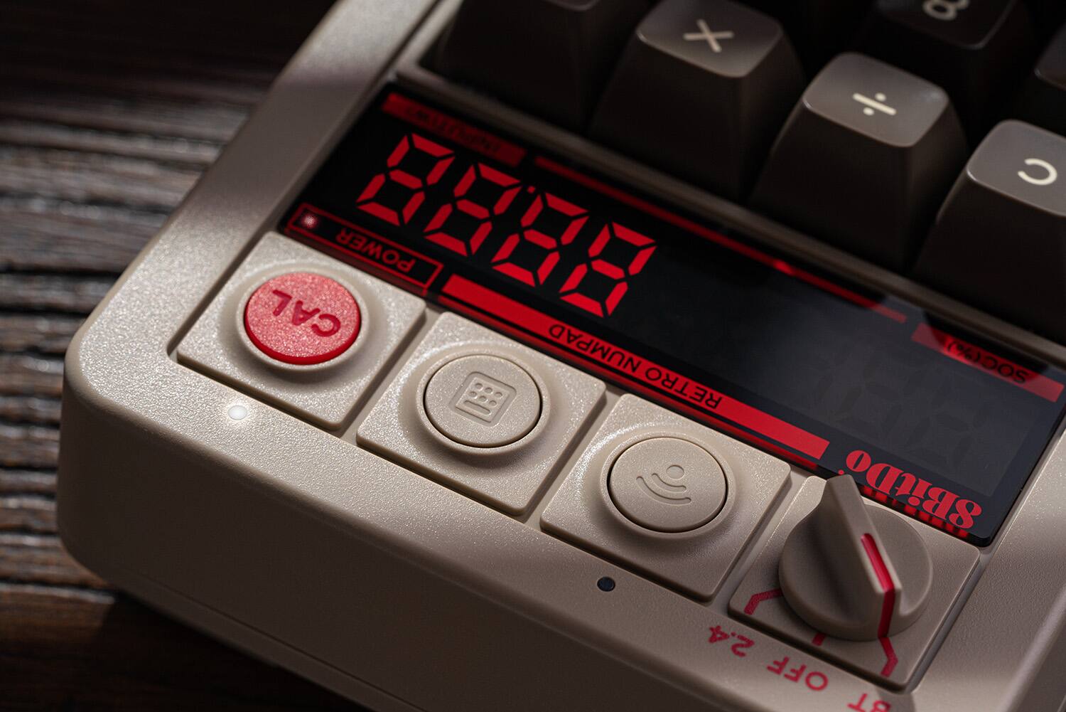 The text on the image reads: "X UTN CAL POWER 8888 NUMPAD RETRO a C SOC(% SBitDo LEREE 2.4 OFF 18". This text seems to be a combination of various phrases and numbers, possibly related to a calculator or a computer keyboard. However, it is not possible to group or correct the text without more context or understanding of the intended message.