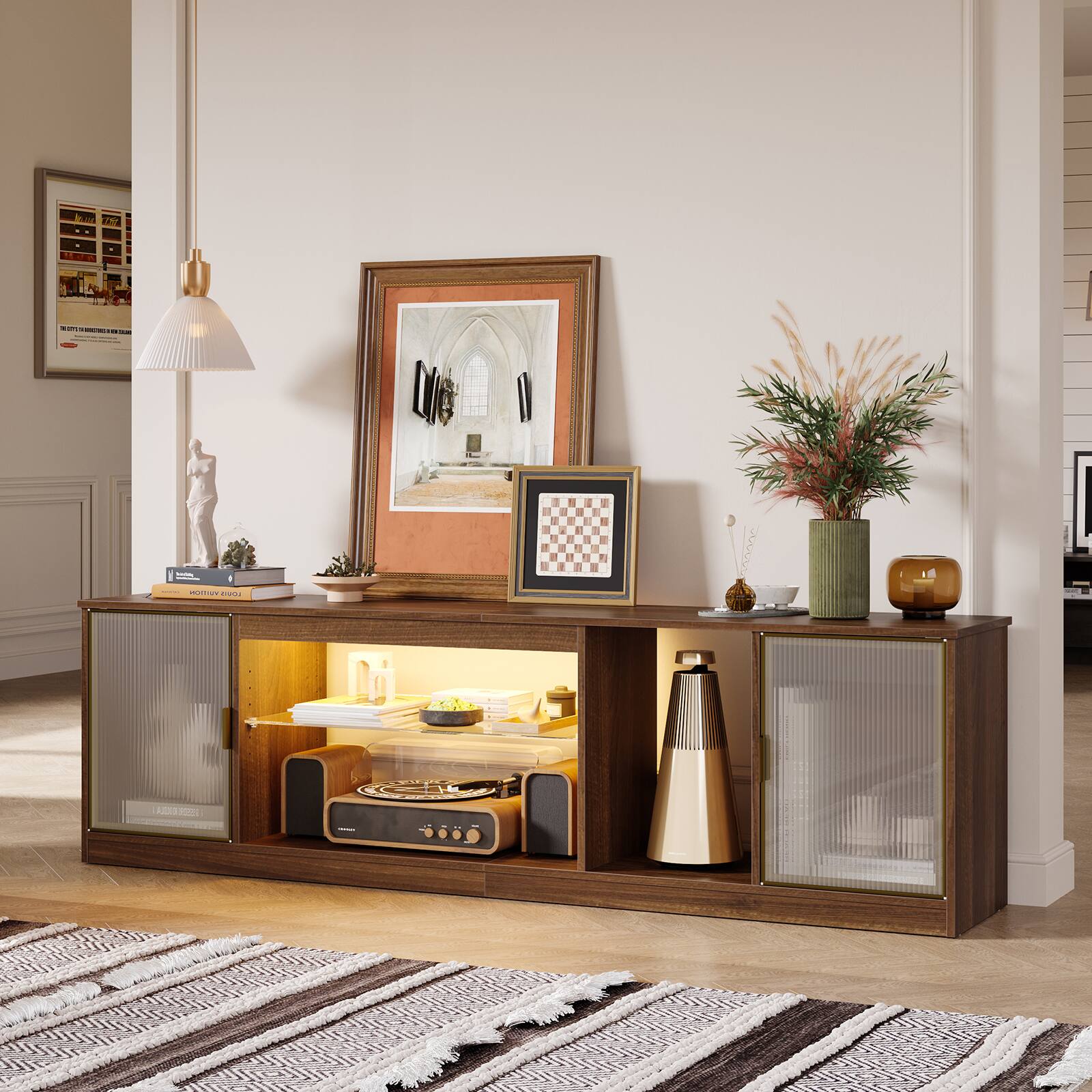 A living room with a wooden cabinet, a lamp, a vase, and a picture on the wall.