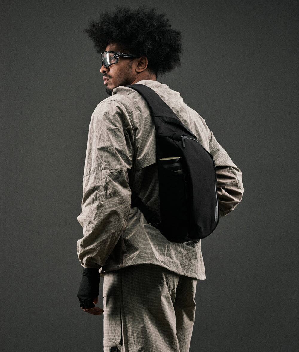 Angle. ALPAKA - Metro Crossbody Left Shoulder Sling Bag Men,Sling Backpack - Fits 11" Tablet - Single Shoulder - Black Axoflux 210D.