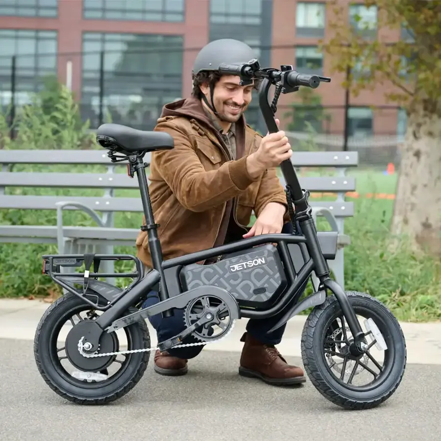 The man is sitting next to a Jetson bike.