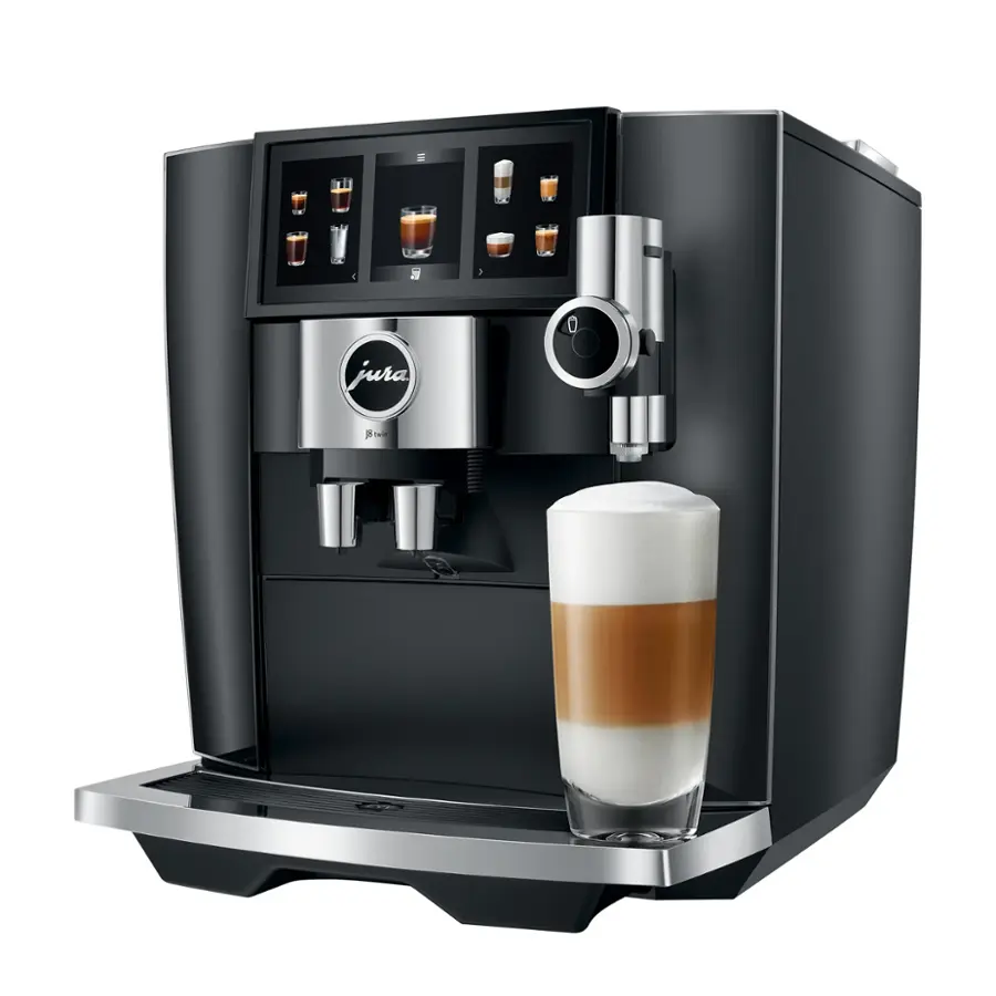 The image features a Jura coffee machine with a glass of coffee in front of it. The machine has a display of various coffee drinks, including a cappuccino, and is ready to serve a drink. The coffee drink is poured into a glass, and the machine is positioned on a counter.