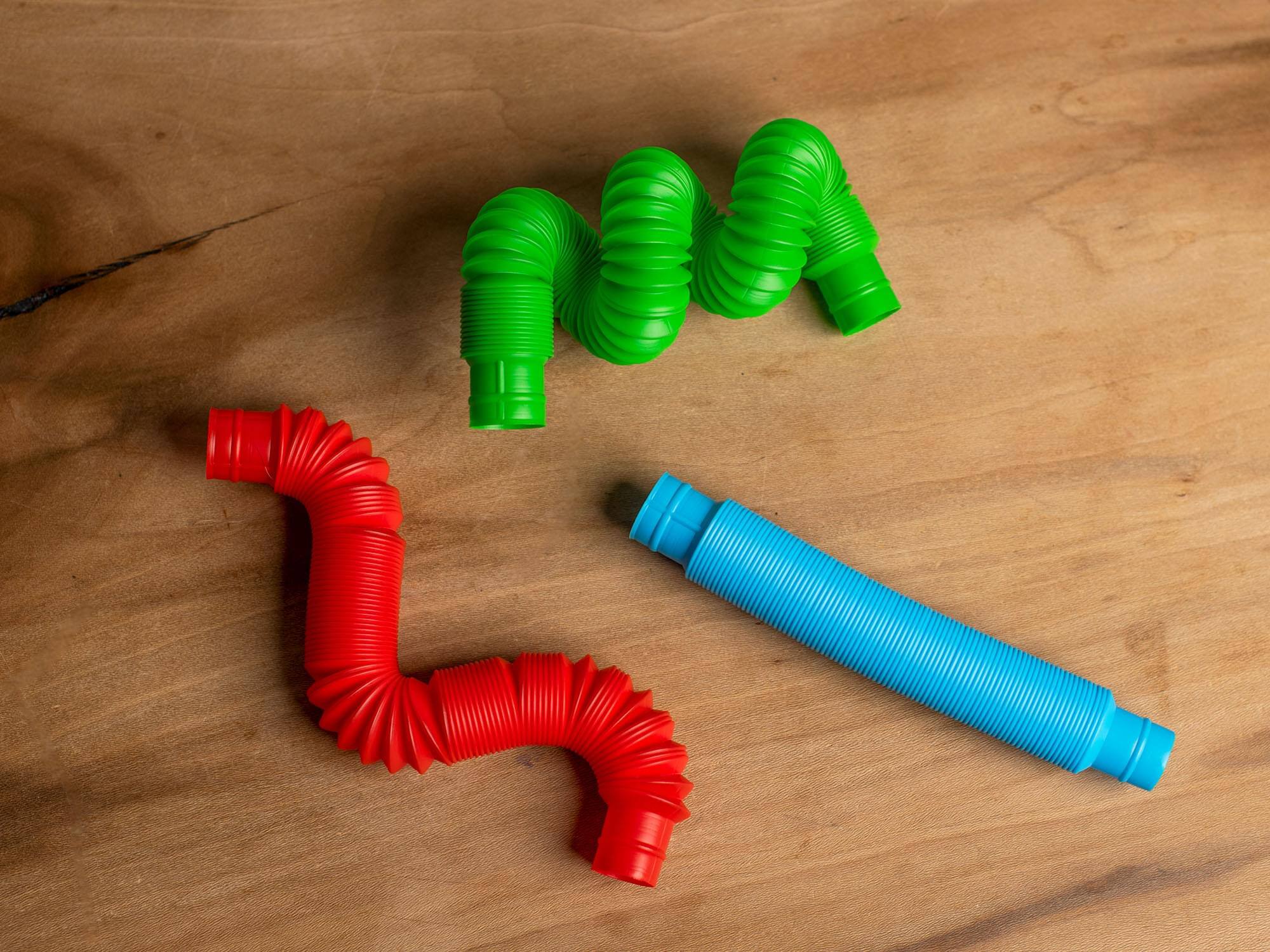 Alt View 1. Toynk - Plastic Sensory Pop Tube Fidget Toys | Set of 3 | Blue, Red, Green - Green.