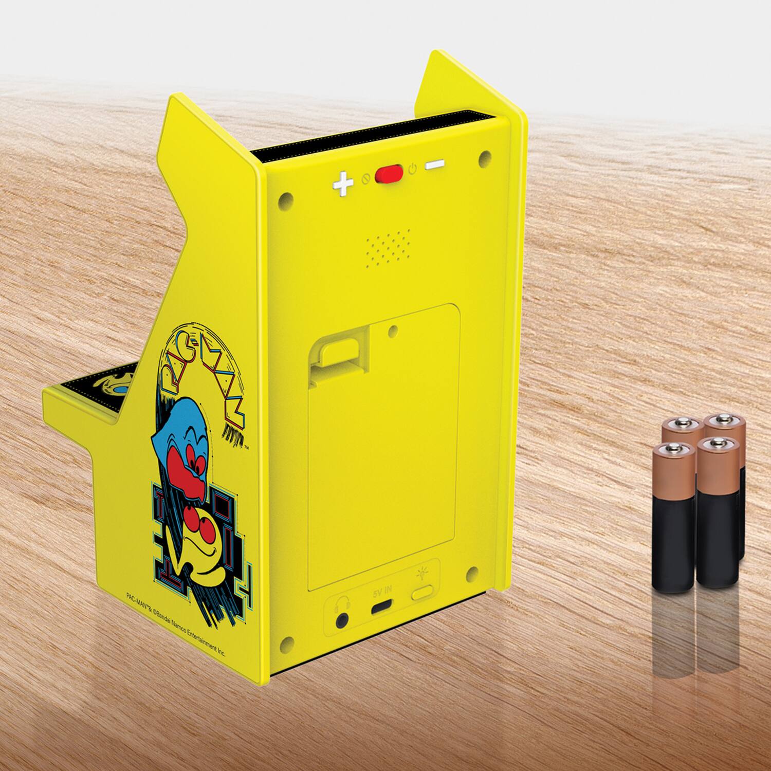 Sure, here is the corrected and grouped text from the image:

---

**Front Side:**
- "PAC-MAN"
- "PAC-MAN's Guide to Video Entertainment Inc."

**Top Side:**
- "+"
- "−"

**Bottom Side:**
- "AV"
- "TV OUT"

**Additional Text:**
- "Atari 2600"

---

This text is based on the visible elements in the image.