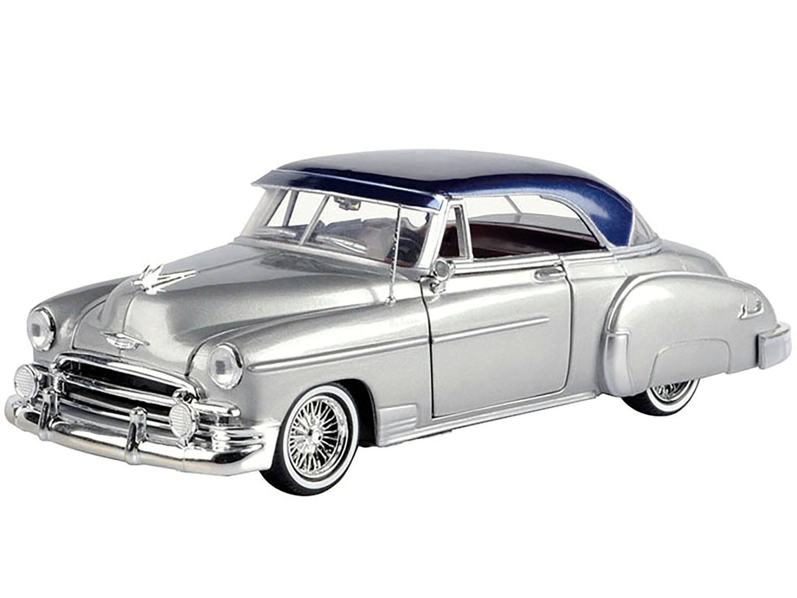 Alt View 1. Motormax - 1950 Chevrolet Bel Air Lowrider Silver Metallic with Blue Metallic Top "Get Low" Series 1/24 Model Car by Motormax.