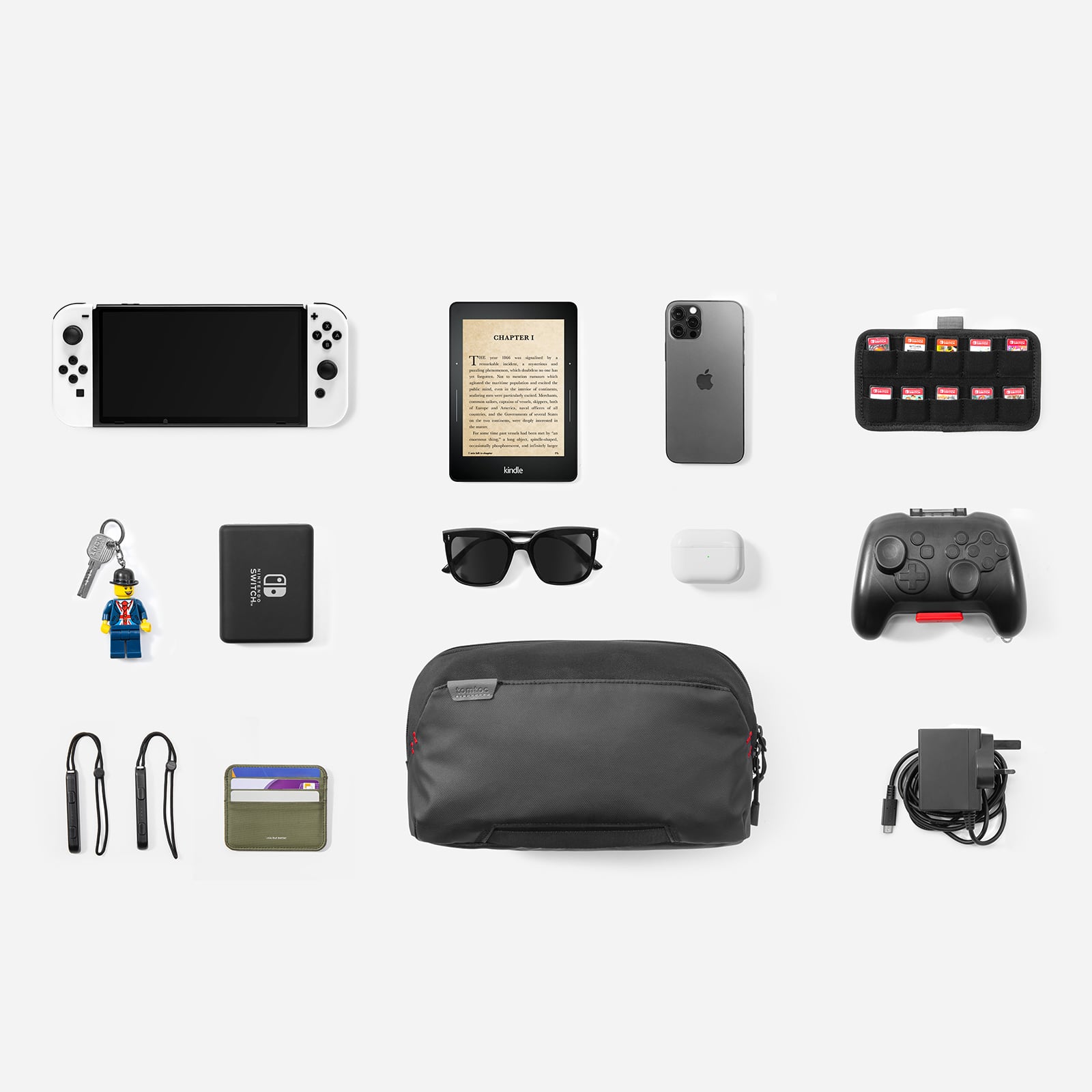 The image shows a collection of various items, including a cell phone, a tablet, a Wii remote, a Nintendo Switch, a book, sunglasses, a key, a wallet, a charger, and a bag. The items are arranged in a grid, with each item occupying a separate square. The cell phone is located in the top left square, the tablet is in the middle left square, the Wii remote is in the top right square, the Nintendo Switch is in the bottom left square, the book is in the middle right square, the sunglasses are in the bottom right square, the key is in the bottom left square, the wallet is in the middle right square, the charger is in the bottom right square, and the bag is in the bottom center square.