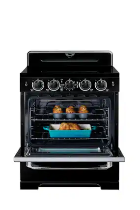 The image shows a black oven with two trays of food inside. The oven has a digital display and is likely a modern, high-tech appliance. The food appears to be cooking well, and the oven is ready to be used.