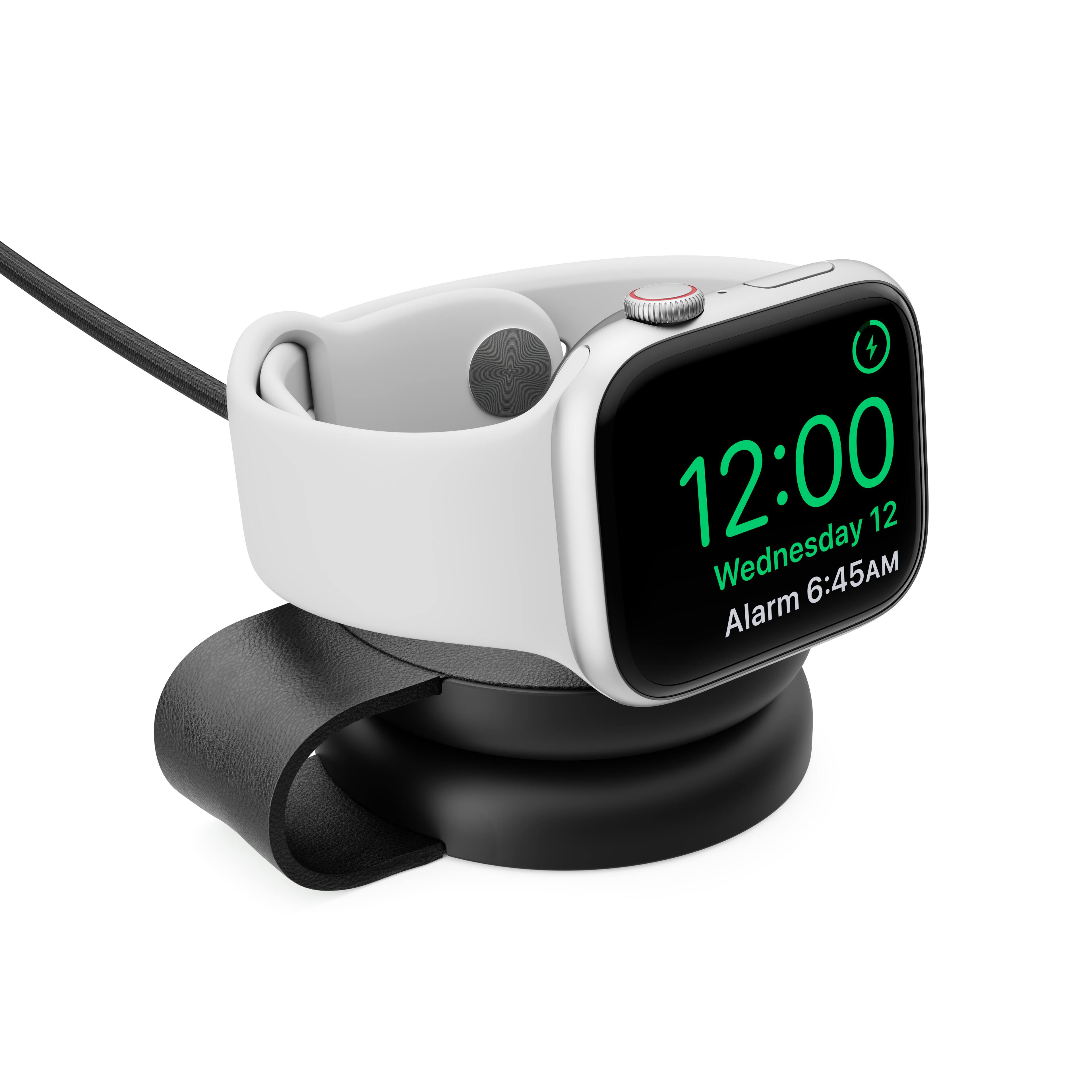 The image shows a white alarm clock with a black face, displaying the time of 12:00. The clock is set on a black stand, and it is set for Wednesday. The alarm is set for 6:45 AM.