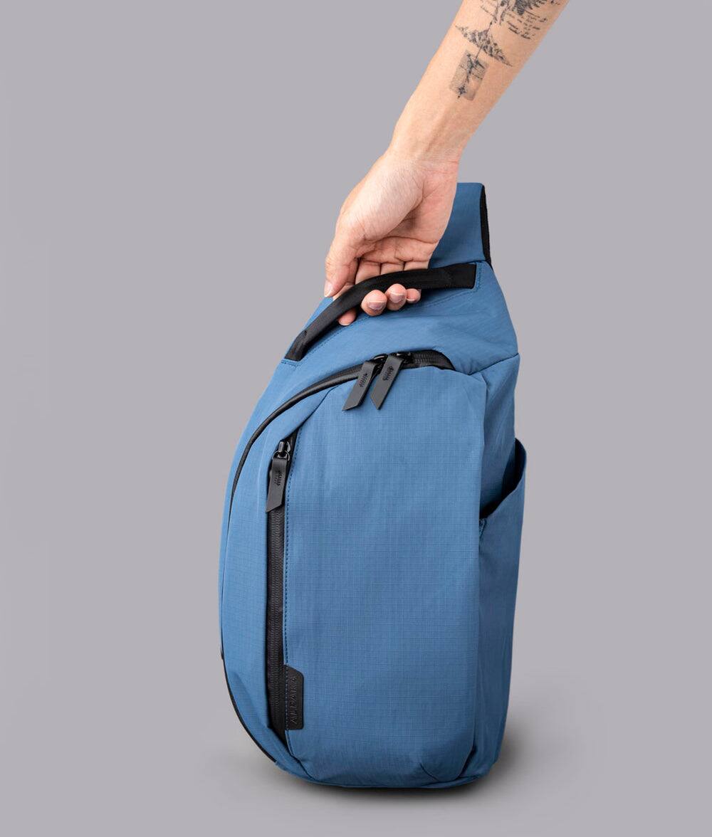 Alt View 1. ALPAKA - Crossbody Sling Bag 7.5L (Right Shoulder) for Men, Fits 11" Tablet, Phone Sleeve, Bottle Pocket, Luggage Pass-Through - Blue Axoflux 210D.
