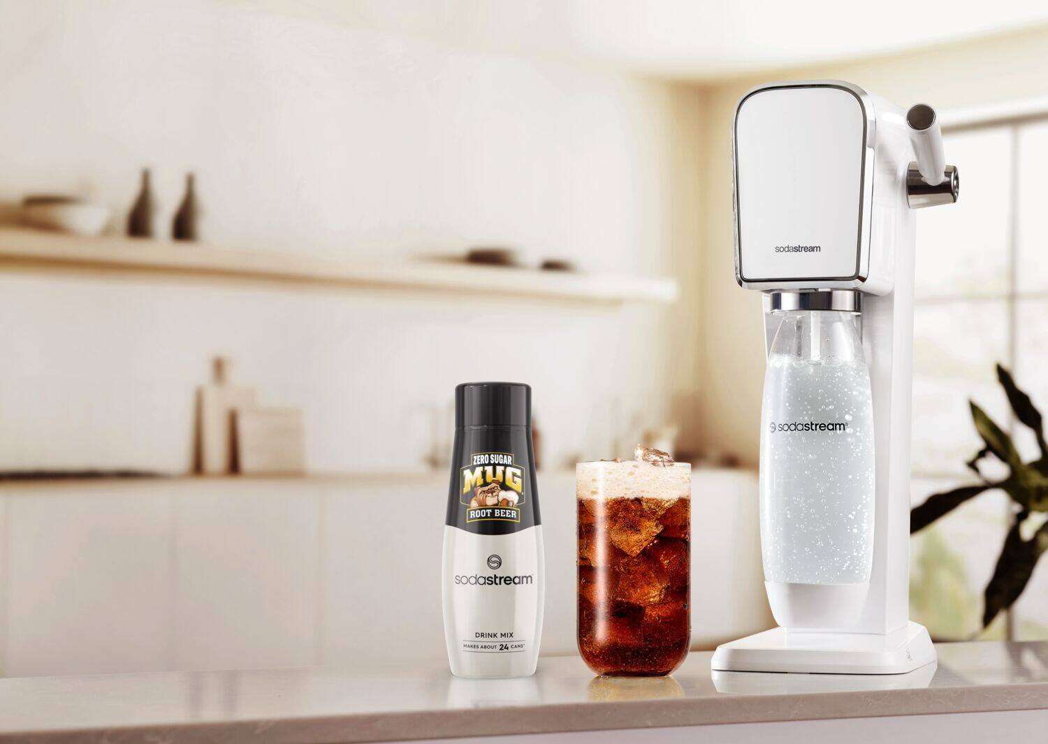 The image features a counter with a SodaStream machine and two bottles of root beer. One of the bottles is a zero sugar version of the root beer, while the other is a regular root beer. The SodaStream machine is placed next to the bottles, ready to be used to make a refreshing beverage.