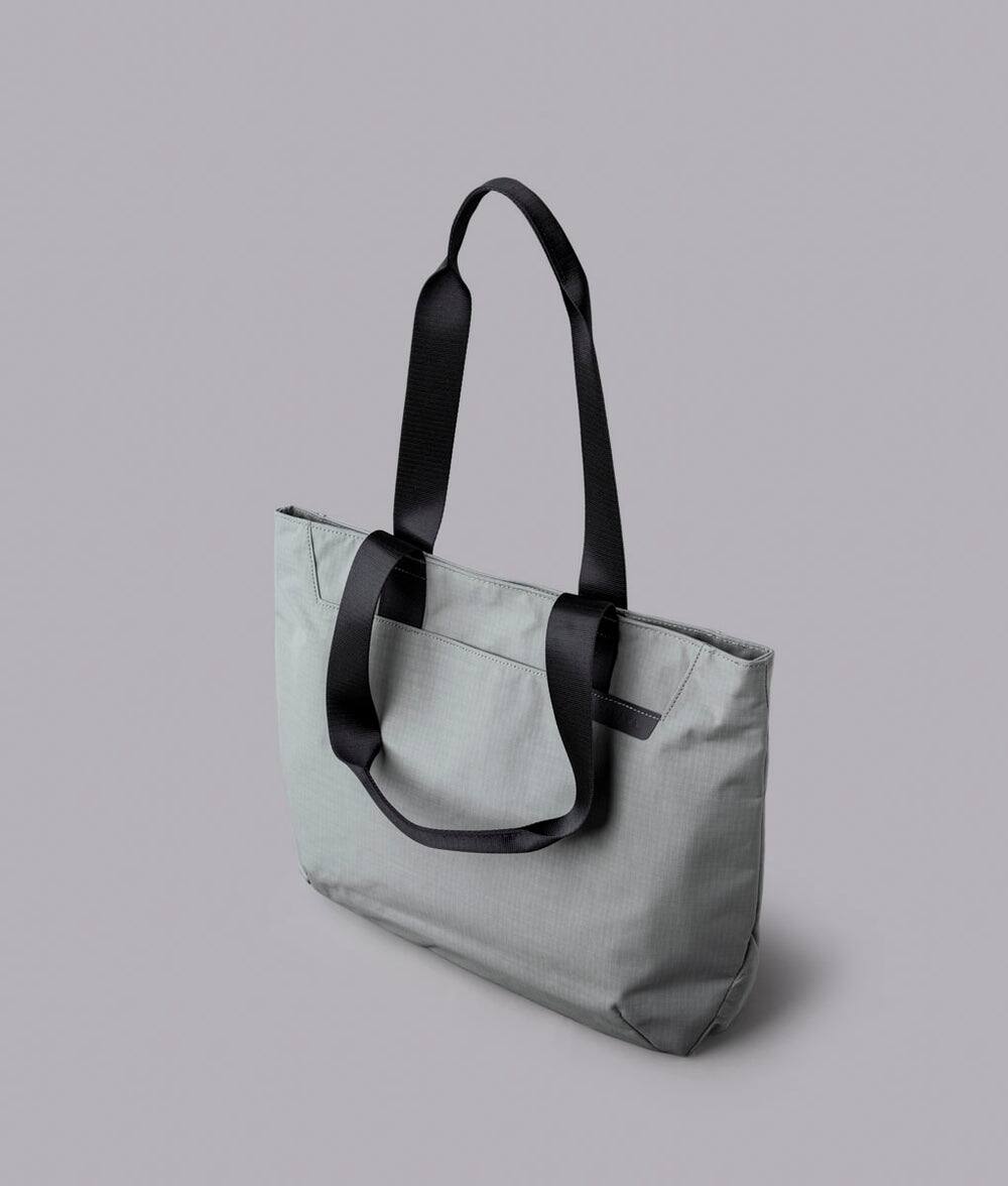 Alt View 1. ALPAKA - Tote Bag Minimalist EDC Travel Tote,14.5L , 2 Bottle Sleeves, Front/Back Slip Pockets, Magnetic Open-Top (No Zipper) - Grey/G Axoflux 210D.