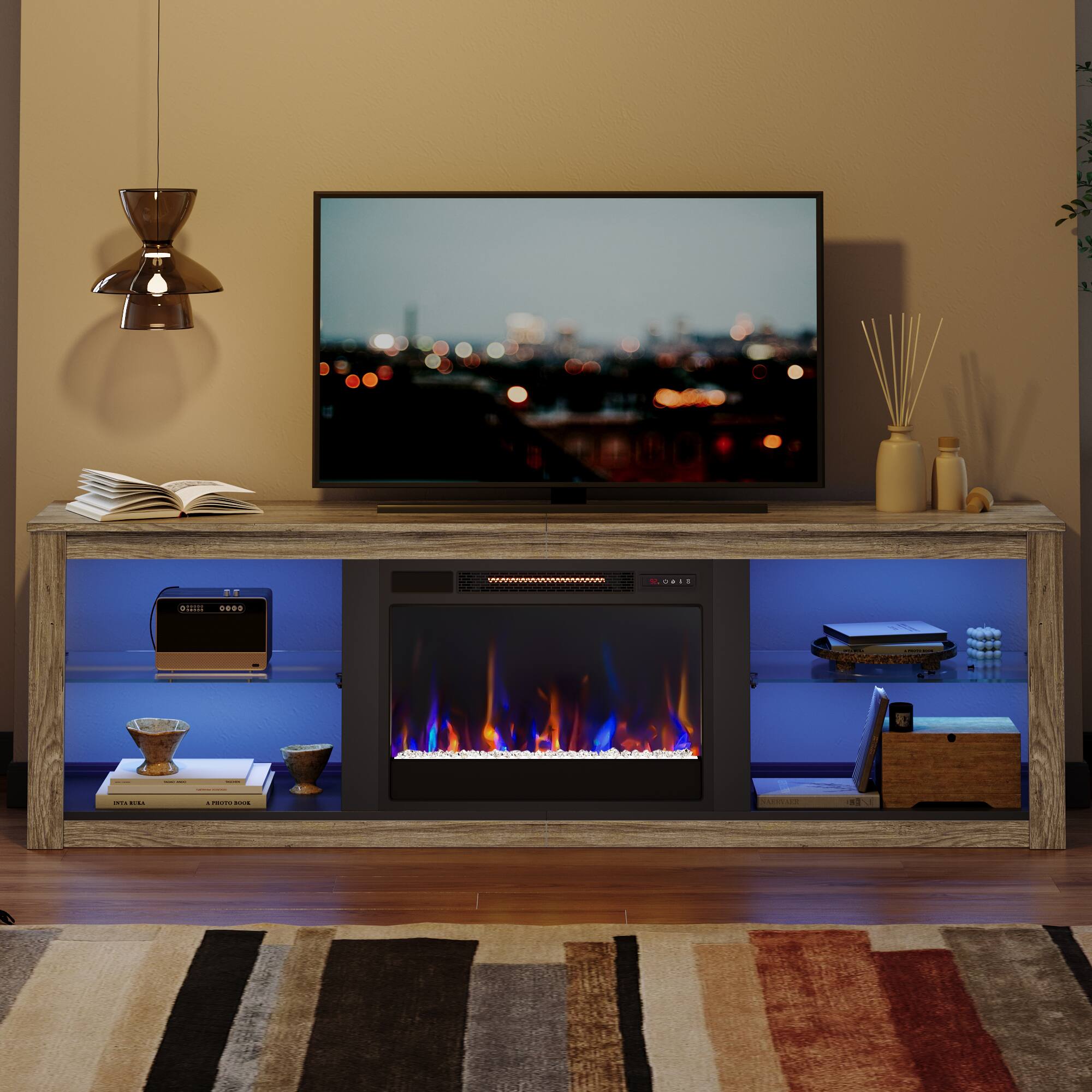 The image features a flat screen TV sitting on top of a wooden entertainment center. The TV is turned on and displaying a fireplace scene. The entertainment center also has a fireplace built into it, creating a cozy and inviting atmosphere. There are several books placed on the shelves of the entertainment center, adding to the overall ambiance of the room. Additionally, there is a vase and a potted plant nearby, further enhancing the decor of the space.