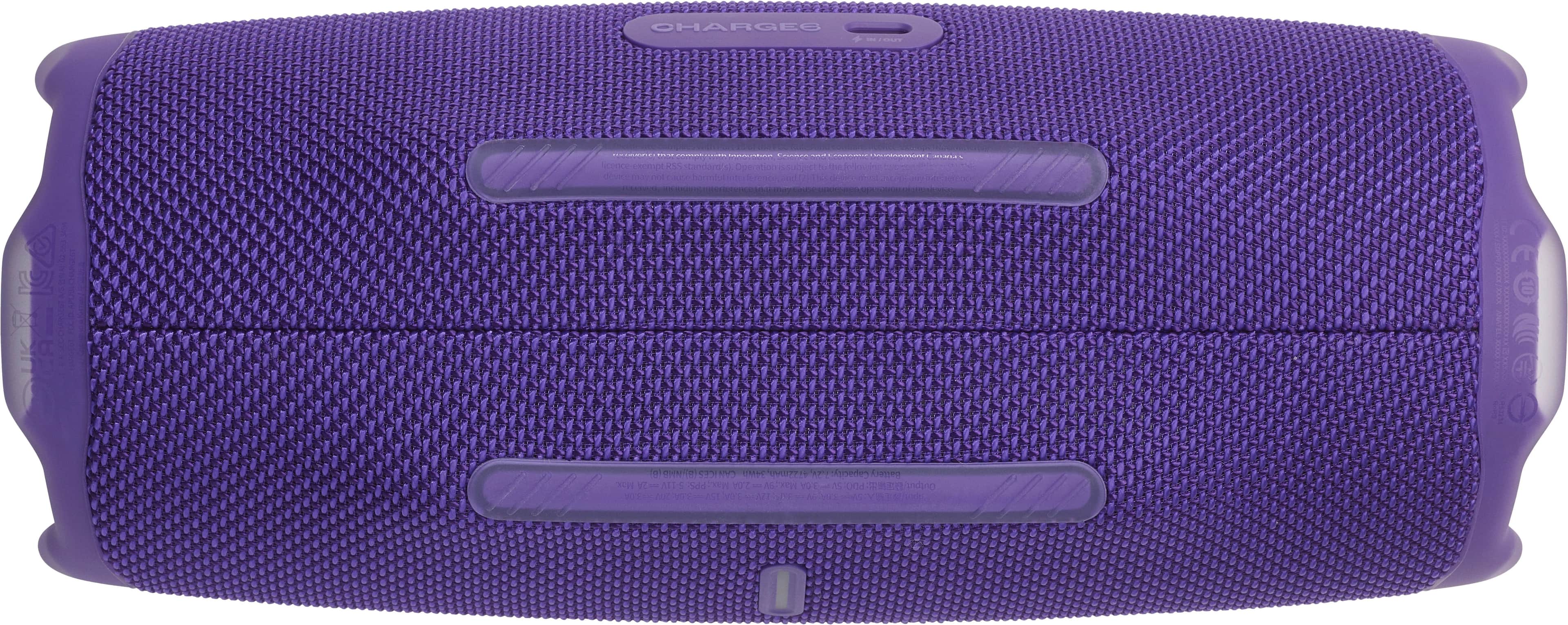 The image shows a purple speaker with a black and white design. The speaker is made by the company JBL and is designed to be waterproof. The speaker is shown in a close-up view, highlighting its unique design and color.