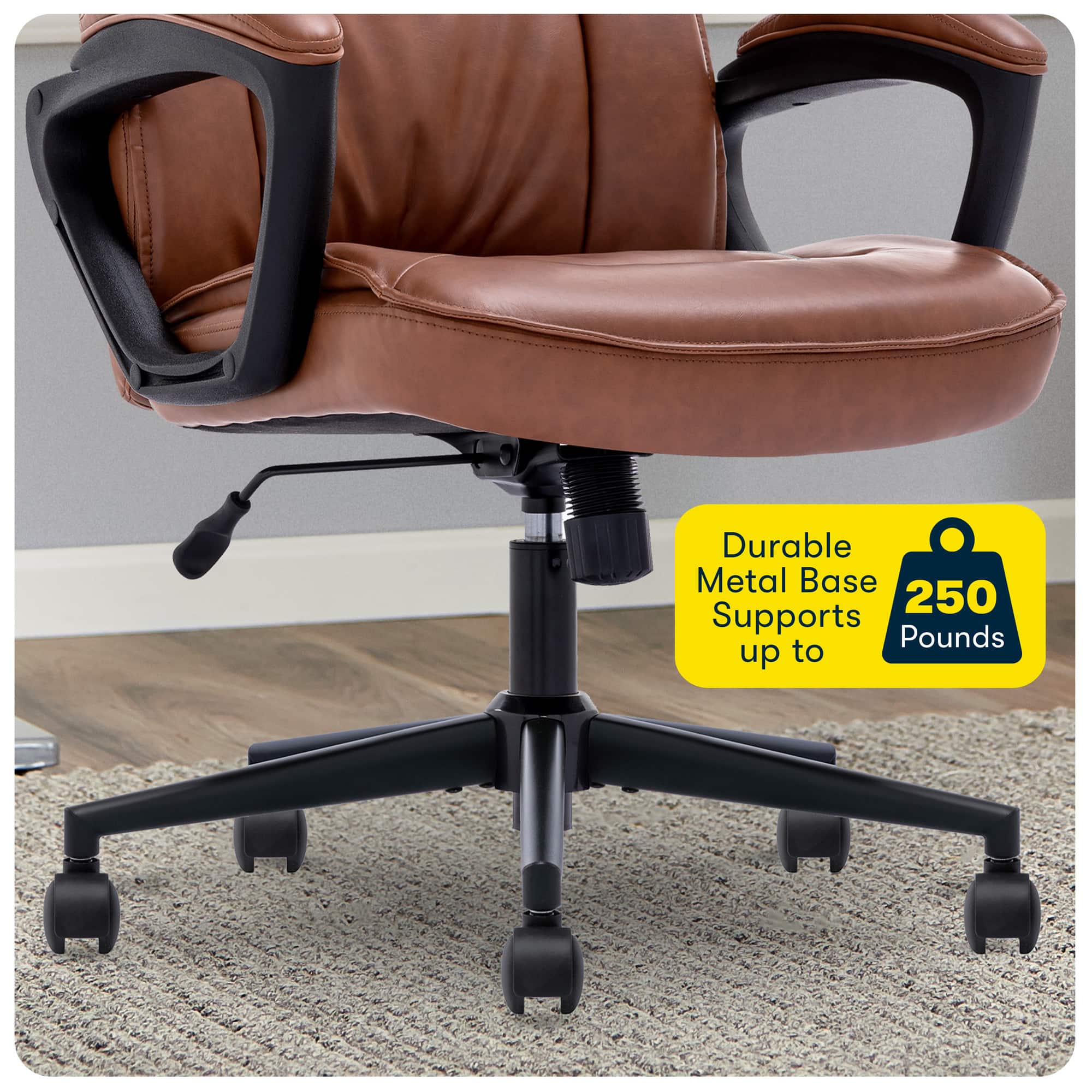 The image features a leather office chair with a metal base, which is designed to support up to 250 pounds. The chair is placed on a carpeted floor, and the metal base provides durability and stability to the chair. The leather material of the chair adds to its comfort and longevity, making it an ideal choice for a workspace.