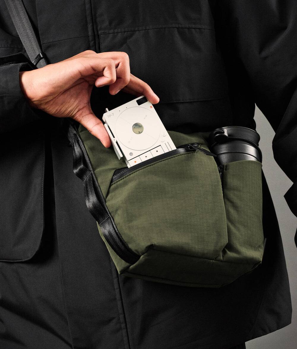 Left. ALPAKA - Flow Satchel Mini 2L Crossbody Bag, Water Resistant Shoulder Bag, Expandable Bottle Pocket, YKK Zippers - Green Axoflux 210D.