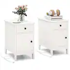 There are two white nightstands in the image. One of them has a vase with flowers and a cup on it, while the other has a clock and a book. Both nightstands have a white color and are placed next to each other.