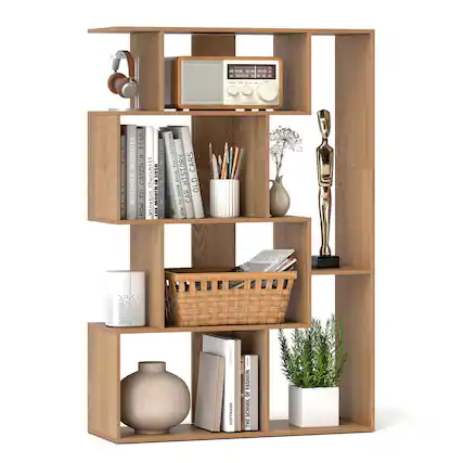 The image features a wooden bookshelf with various items on it. There are several books of different sizes, a radio, a vase, a statue, and a potted plant. The books are arranged in a way that they are visible and easily accessible. The presence of a radio and a statue adds a decorative touch to the bookshelf, making it a functional and aesthetically pleasing piece of furniture.