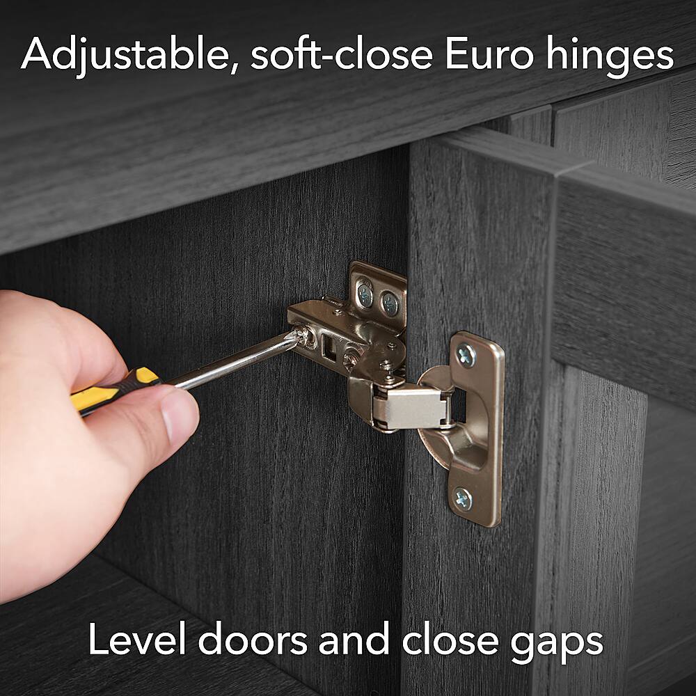 The image shows a person using a tool to adjust the hinges on a door, which are described as "adjustable, soft-close Euro hinges." The person is working on the hinges to ensure that the door closes properly and smoothly. The hinges are designed to provide a level door and close gaps, ensuring a secure and aesthetically pleasing fit.