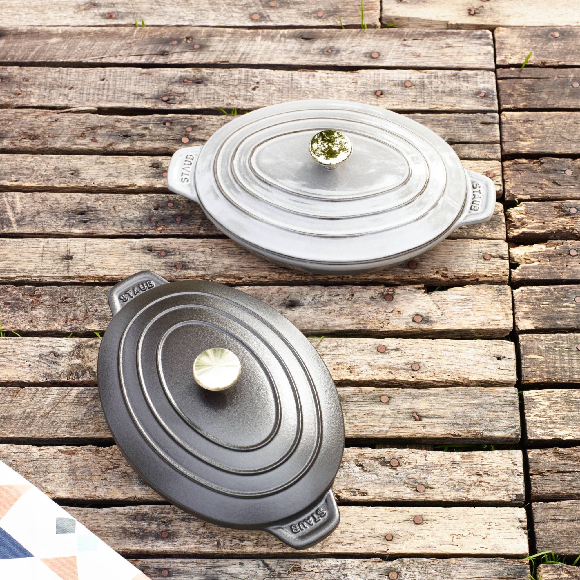 The text on the image reads:

- "STAUB" (on the lid and the base of the pot)
- "STAUB" (on the base of the pan)