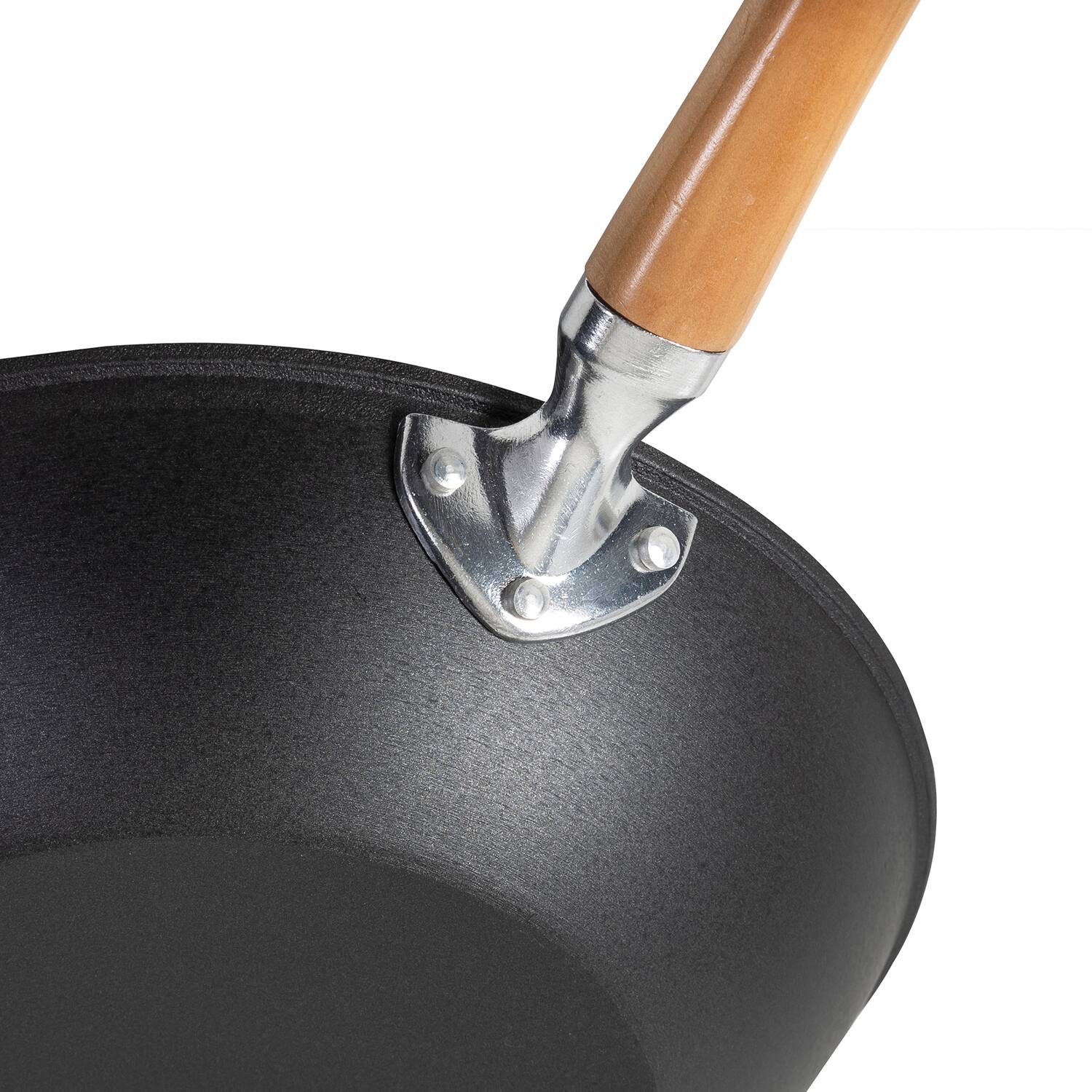 Angle. Escali - Joyce Chen Professional Series 11.5-Inch Preseasoned Cast Iron Stir Fry Pan with Maple Handle - Black.