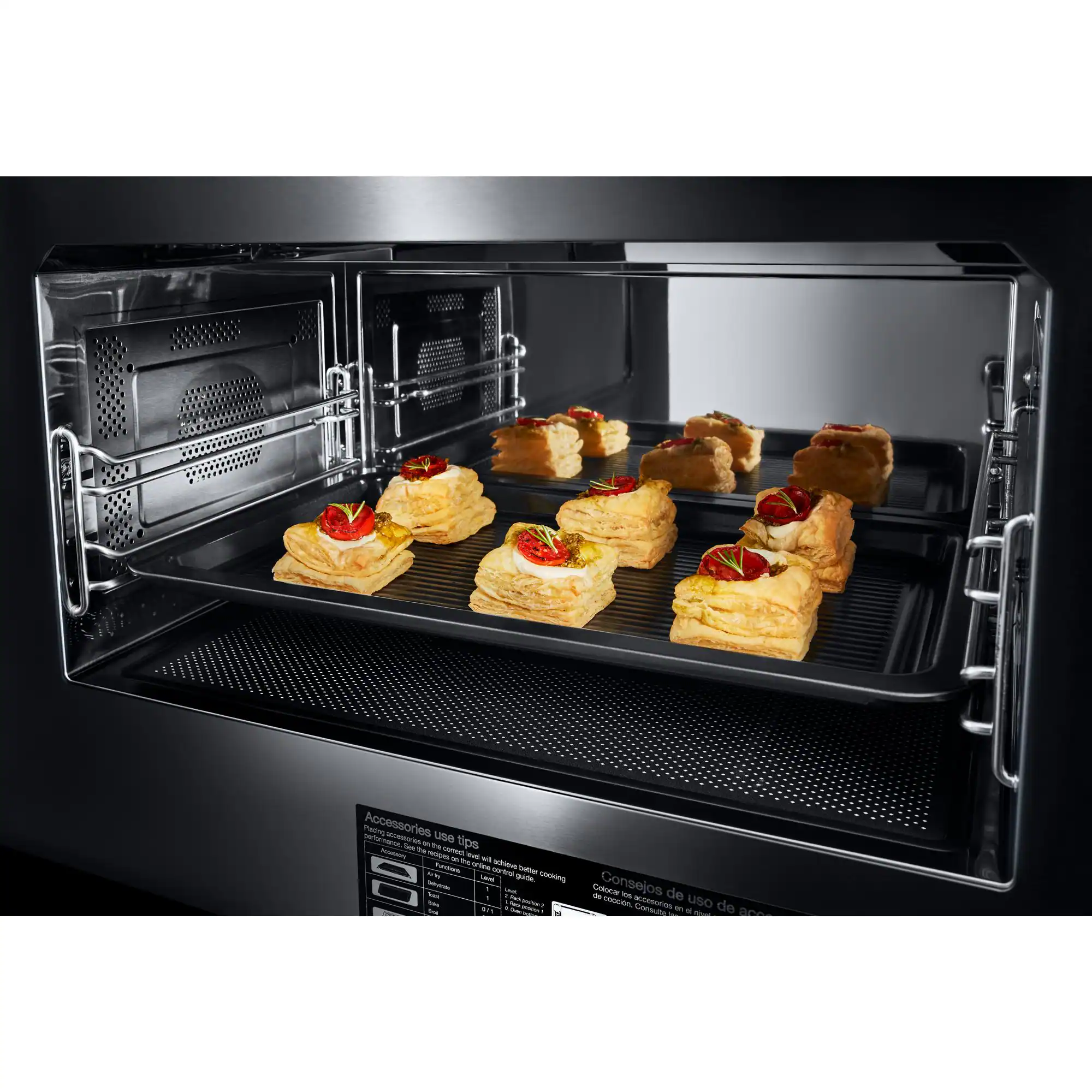 The image shows a toaster oven with a tray of food inside. The food consists of several small sandwiches or pastries, which are evenly spaced and arranged on the tray. The oven is open, allowing us to see the food clearly. The image does not provide any text or instructions related to the use of the oven or the food.