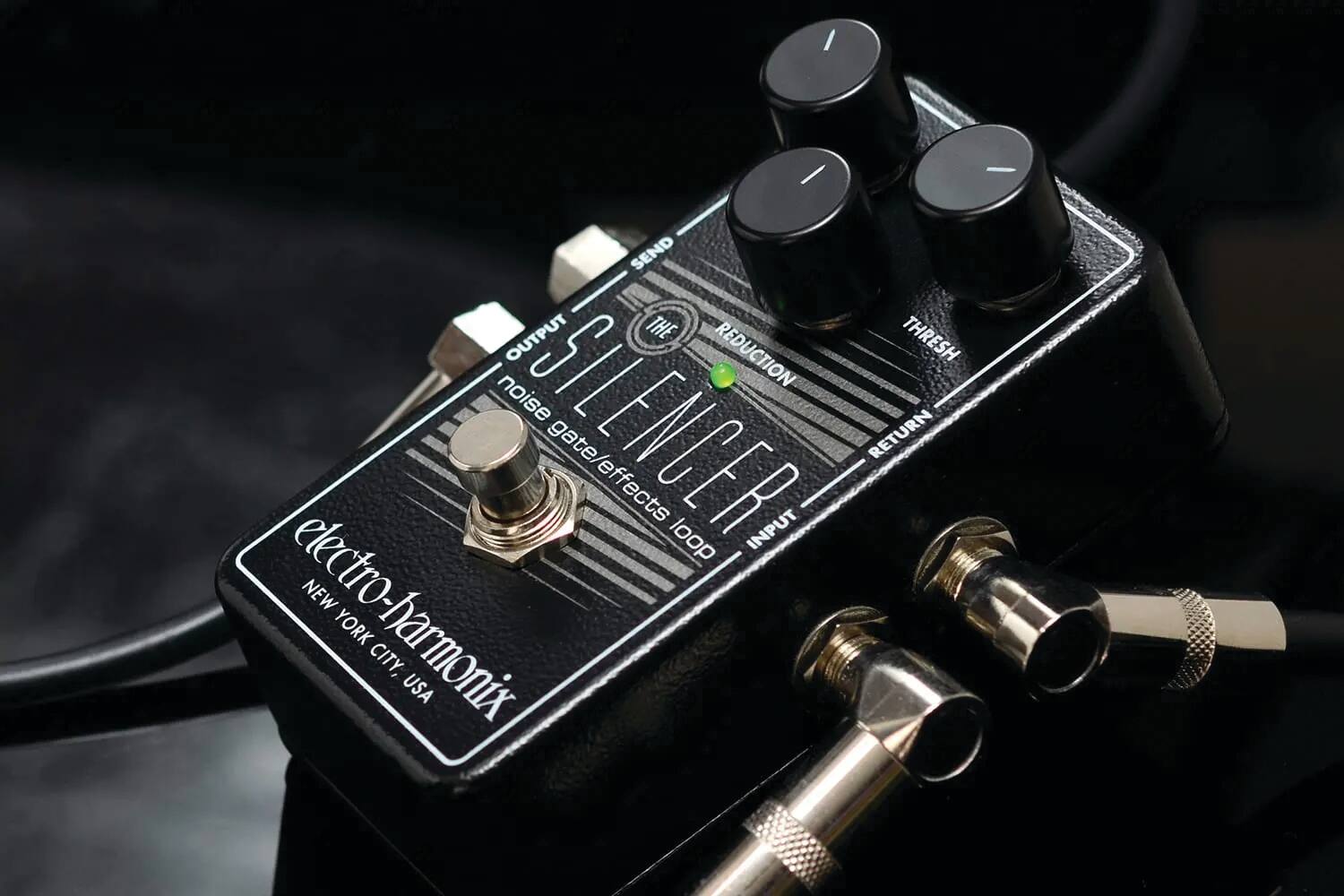The text on the image reads:

"THE SILENCER
noise gate
REDUCTION
THRESH
RETURN
SEND
INPUT
OUTPUT
electro-harmonix
NEW YORK CITY, USA"