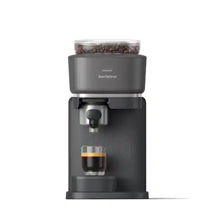 The image features a black coffee maker with a glass of coffee and a cup of coffee beans. The coffee maker is made by Philips and is designed for making espresso. The beans are placed in a container on top of the machine, and the coffee is poured into a cup. The machine is ready to make a delicious cup of coffee for someone to enjoy.