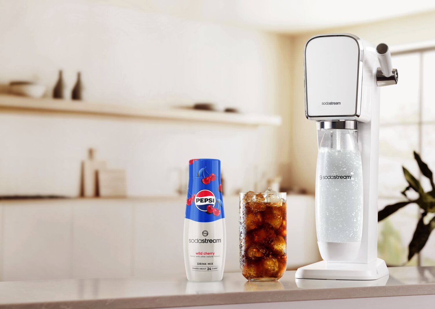The image features a kitchen counter with a SodaStream machine and a bottle of Pepsi. There is also a bottle of wild cherry soda on the counter. The SodaStream machine is designed to make carbonated beverages at home, allowing users to create their own customized drinks with a variety of flavors and ingredients. The presence of these items on the counter suggests that someone might be preparing to make a refreshing drink using the SodaStream machine and the soda flavors available.