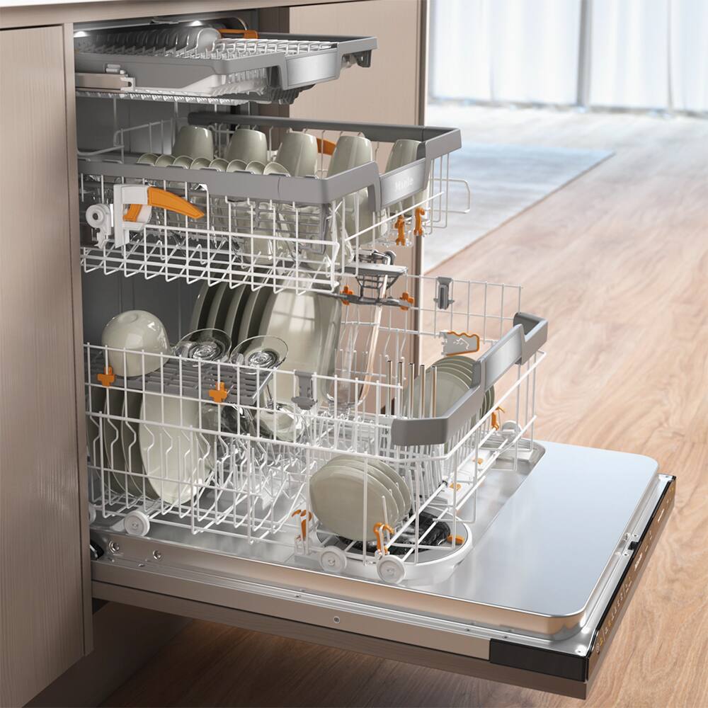 The image shows a dishwasher with a silver rack holding various dishes, including plates, cups, and bowls. The dishwasher is filled with dishes, and it appears to be a modern and efficient appliance. The dishes are arranged neatly in the rack, indicating that they are being washed and prepared for use. The dishwasher is likely located in a kitchen, and its presence suggests that the homeowner values cleanliness and convenience in their daily routine.