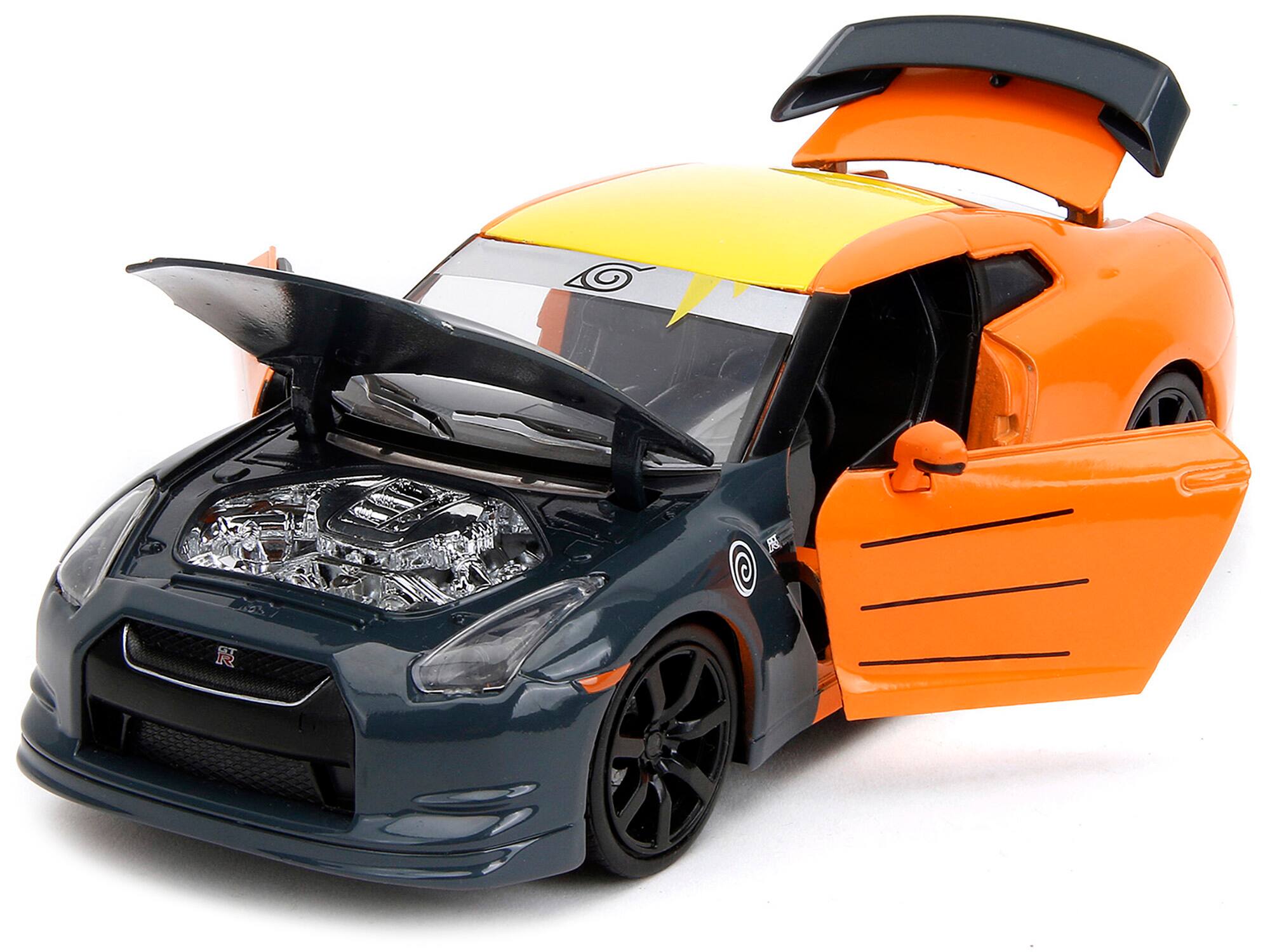 Angle. Jada - 2009 Nissan GT-R R35 Orange Dark Gray Yellow Top Graphics with Naruto Figure Naruto Shippuden Anime 1:24 Diecast - Orange, Dark Gray, Yellow.