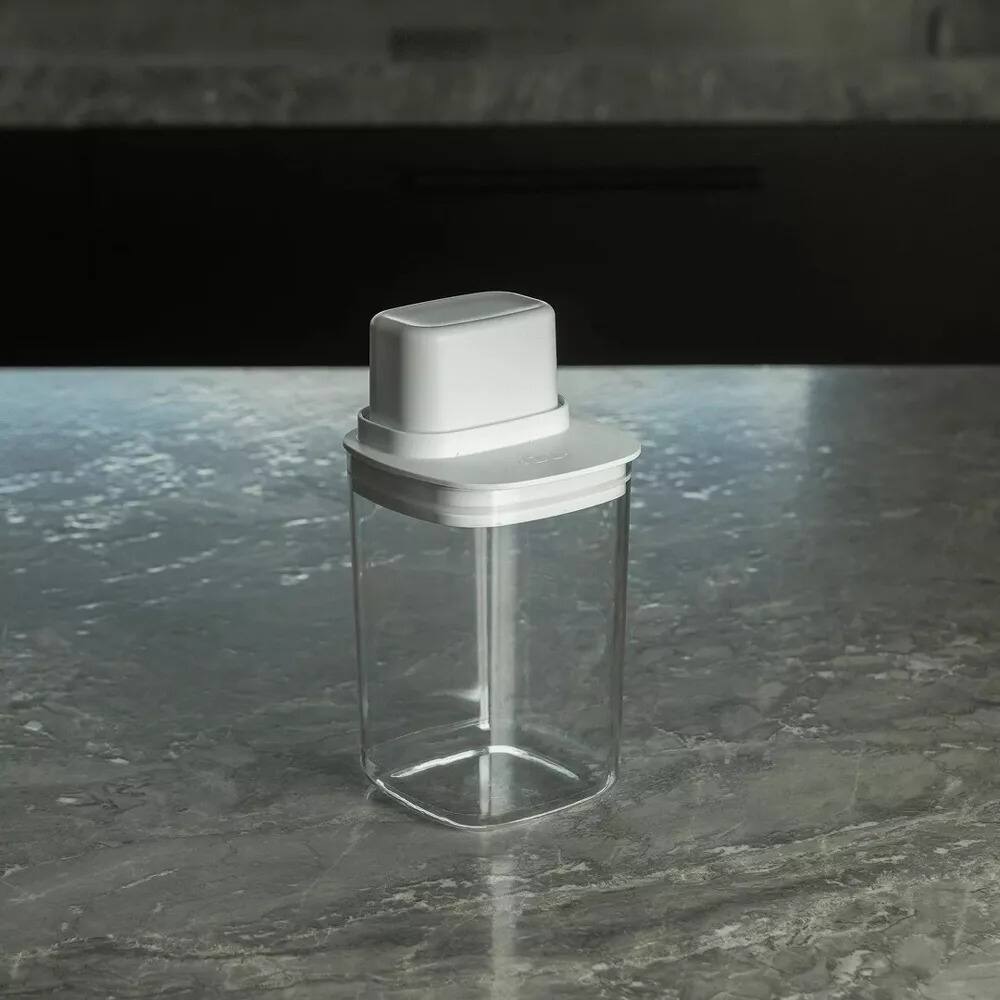 Left. OU - 4 Cup Clear Airtight Food Storage Container with Measuring Cup for Sugar, Coffee & Dry Food - White.