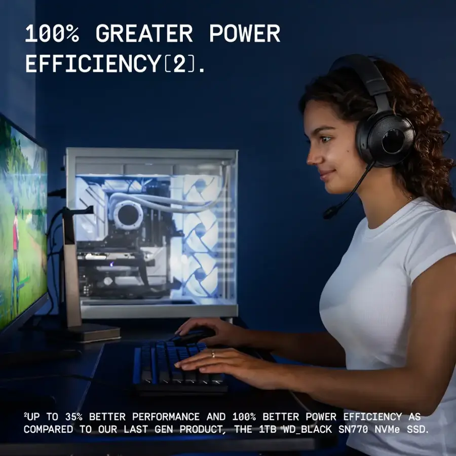 The image features a woman wearing headphones and typing on a computer keyboard. The text on the image states that there is a 100% greater power efficiency compared to the last generation product, the 1TB WD\_BLACK SN770 NVMe SSD. Additionally, the product offers up to 35% better performance.