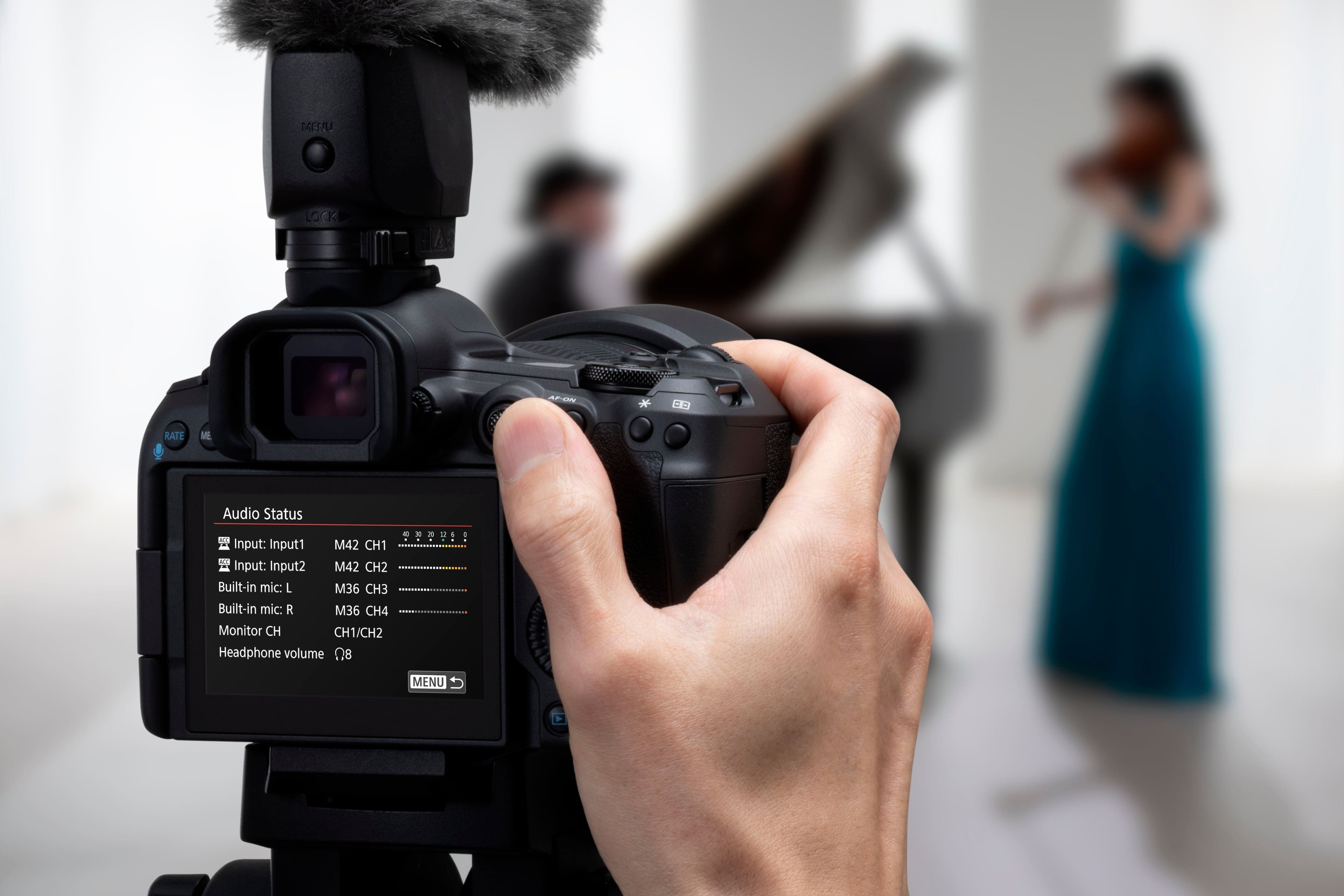 The text on the image reads: "T4ESRL LOCK AF-ON * RATE ME Audio Status 130 : - Input: Input1 M42 CH1 input: Input2 M42 CH2 Built-in mic L M36 CH3 Built-in mic R M36 CH4 Monitor CH CH1/CH2 Headphone volume 08 MENU."