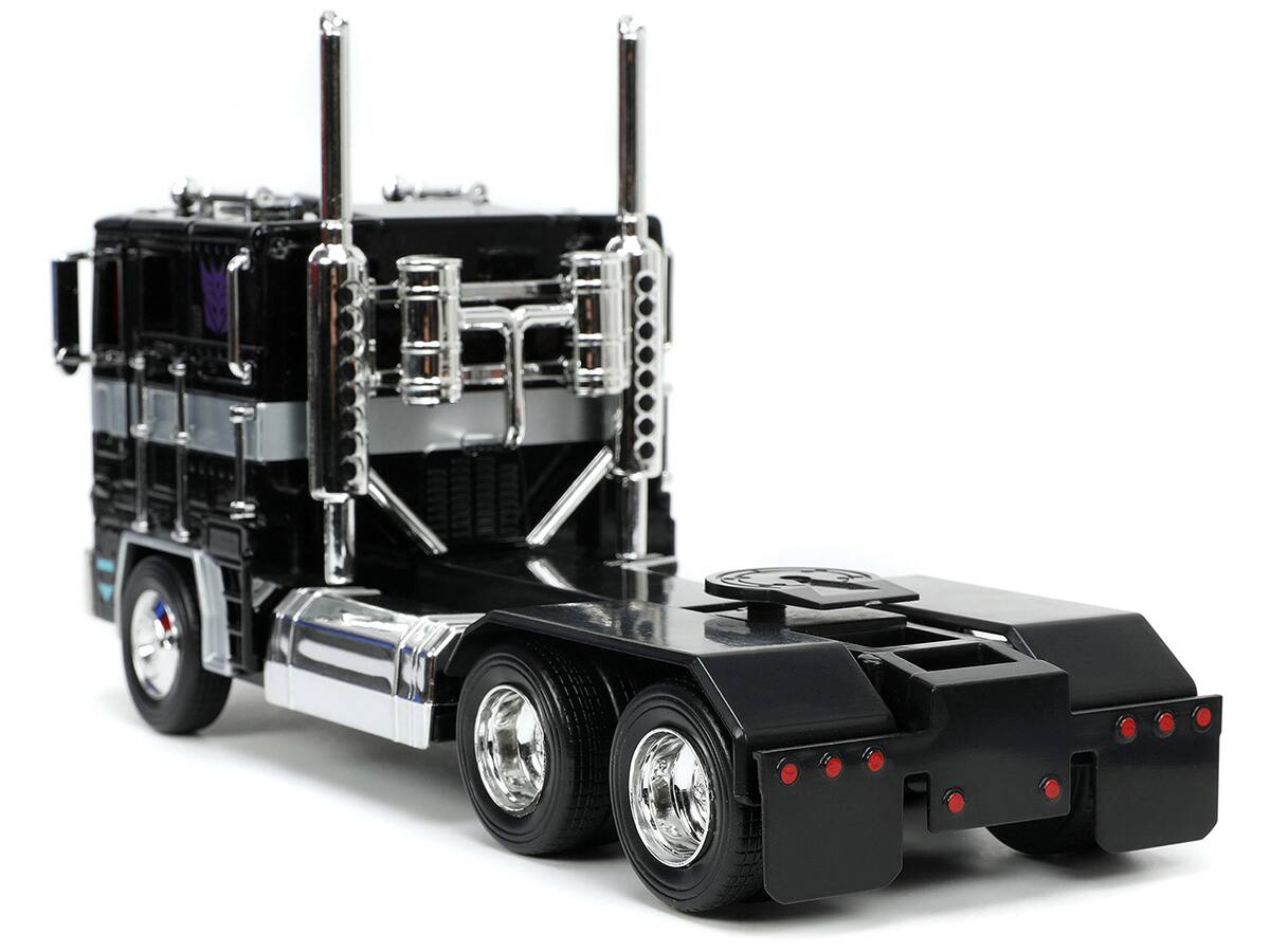 Left. Jada - Decepticon Nemesis Prime with Robot on Chassis "Transformers" TV Series "Hollywood Rides" Series 1/24 - Black.