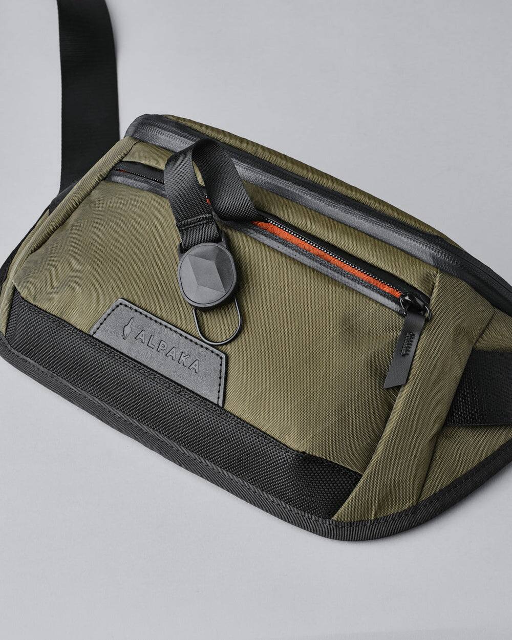 Alt View 2. ALPAKA - Sling Bag Bag for Men, Fits iPad Mini & Switch OLED, Hidden Rear Pocket, Magnetic Buckle, YKK AquaGuard Zippers - Olive Green X-Pac X42.