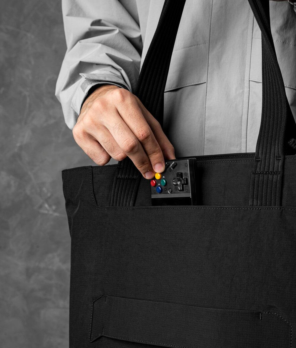 Left. ALPAKA - Flight Tote (L) Laptop Tote Bag for Work, Large Tote Bag Fits 16" MacBook Pro, Water Bottle Pocket, Luggage Pass-Through - Black Axoflux 400D.