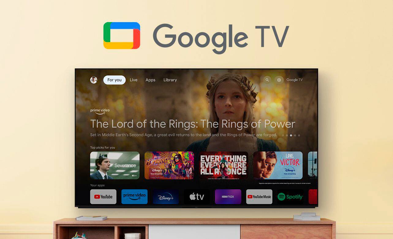 Google TV offers a variety of content, including live apps, a library of shows and movies, and popular streaming services such as Prime Video, Disney+, and HBO Max. In the image, the Google TV screen displays a selection of top picks, including "The Lord of the Rings: The Rings of Power," "Severance," "Everthing, Everywhere, All at Once," "Love," and "Victor." Additionally, the screen features icons for YouTube, Apple TV, and Google Play, showcasing the diverse range of content available on Google TV.