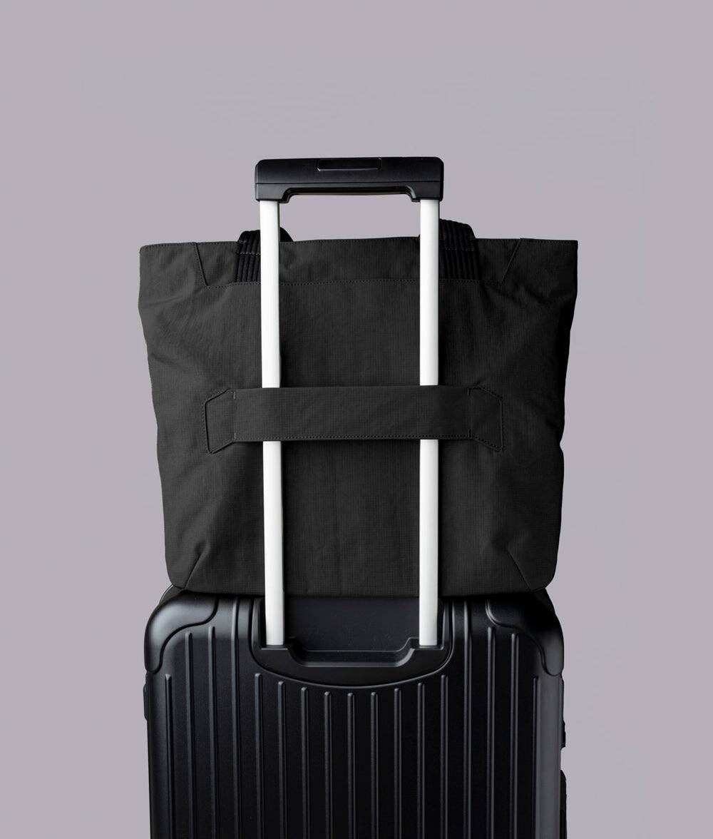 Alt View 1. ALPAKA - Flight Tote (L) Laptop Tote Bag for Work, Large Tote Bag Fits 16" MacBook Pro, Water Bottle Pocket, Luggage Pass-Through - Black Axoflux 400D.