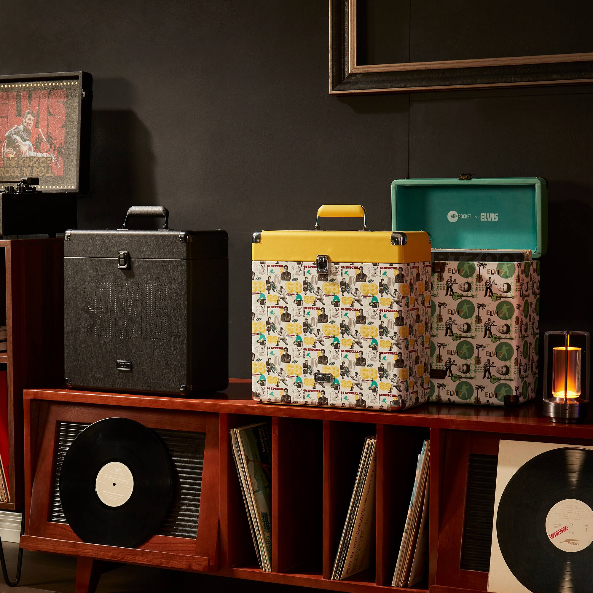 Sure, here is the corrected and grouped text from the image:

---

**Top Left:**
- ELVIS
- THE KING OF ROCK 'N ROLL

**Top Right:**
- ELVIS
- ROCK 'N ROLL

**Middle Left:**
- ELVIS

**Middle Right:**
- ELVIS

**Bottom Left:**
- ELVIS

**Bottom Right:**
- ELVIS

**On the Record:**
- ELVIS

**On the Box:**
- ELVIS

**On the Candle:**
- ELVIS

---

This text is likely part of the branding and design elements in the image, featuring the name "ELVIS" prominently.