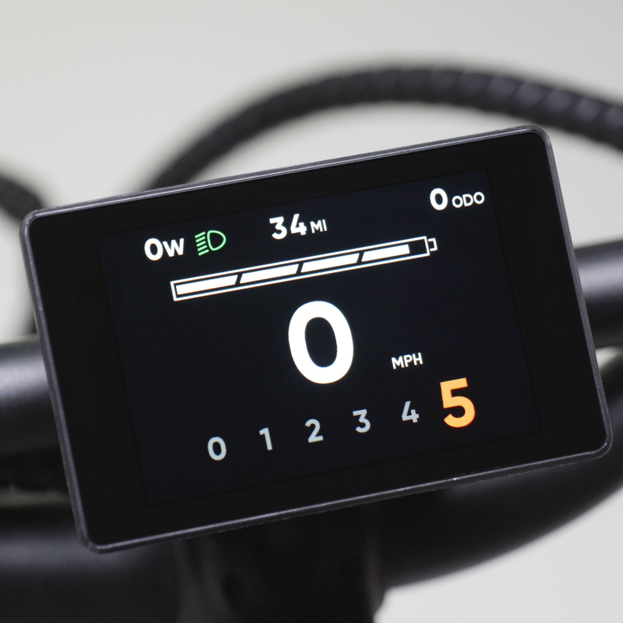 The text on the image reads: "ODO 34 4 MI Ow 01234 2 3 4 5 O MPH." The correct grouping and text would be: "ODO 34 4 MI Ow 01234 2 3 4 5 O MPH."