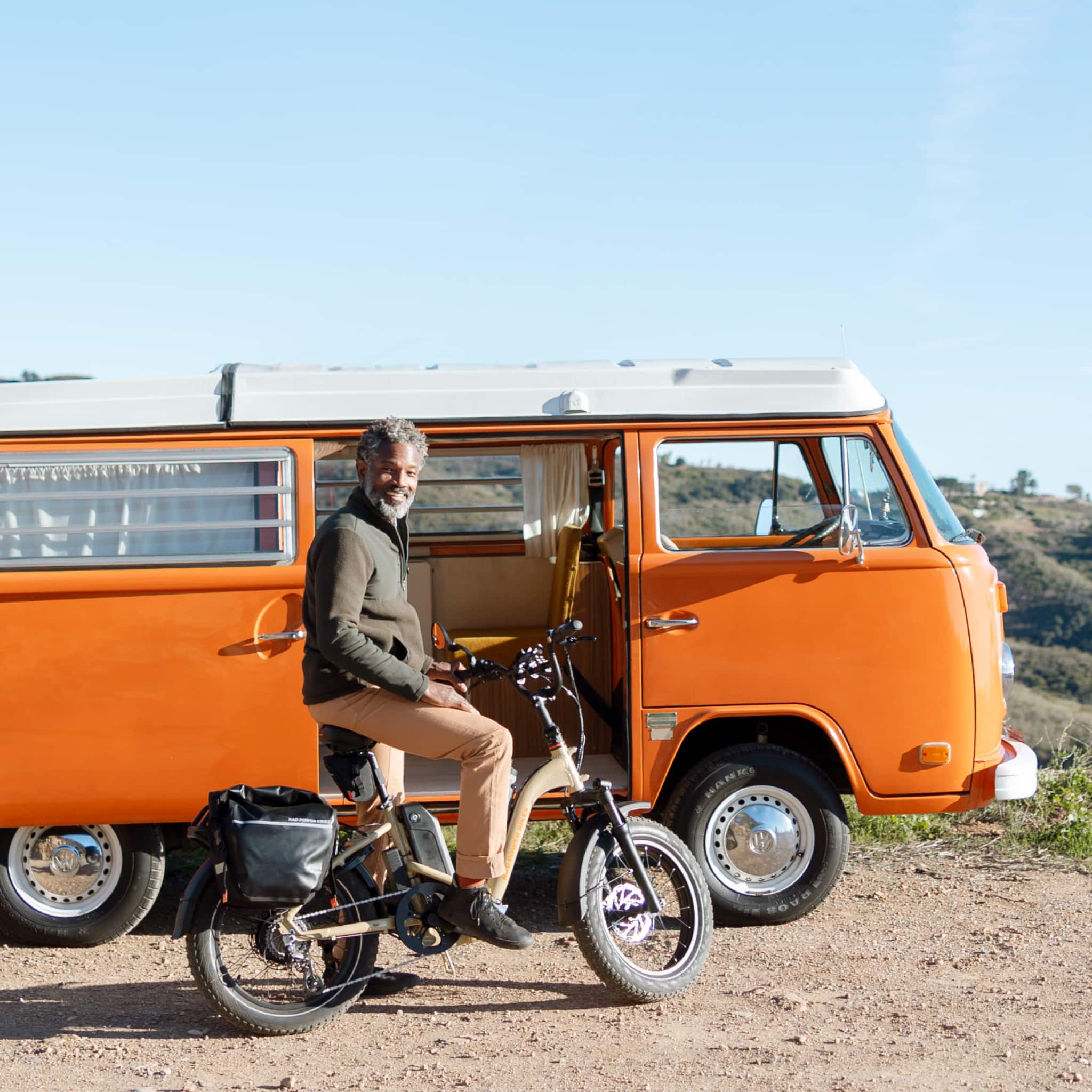 "Heani Sove" is not a valid grouping of text. The image shows a man sitting on a bicycle next to a van.