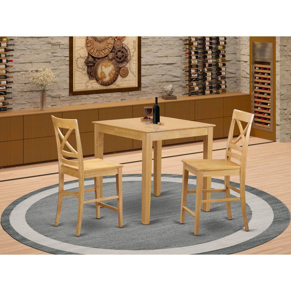 The image shows a dining area with a wooden table and two chairs placed on a circular rug. The background features a wine rack filled with bottles and a decorative wall art piece.