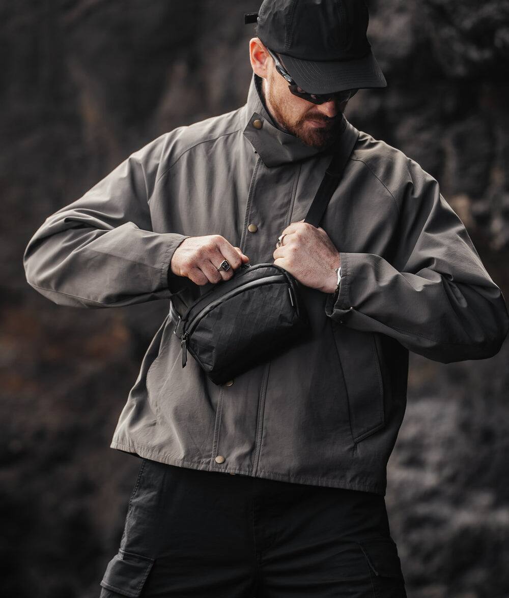 Alt View 6. ALPAKA - Flight Sling 1L Travel Sling Bag, Lightweight Crossbody Pouch, Phone Sleeve, Passport Pocket, Detachable Strap - Black Ultradyne 100D.