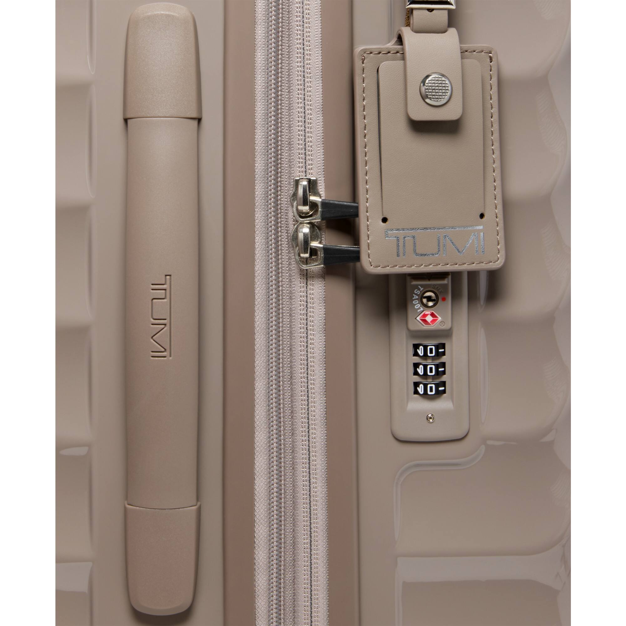 The text on the image is: "TUMI M TUMI SN 7SA007 = 0 0 - 0 6 - 0 6 0 -"