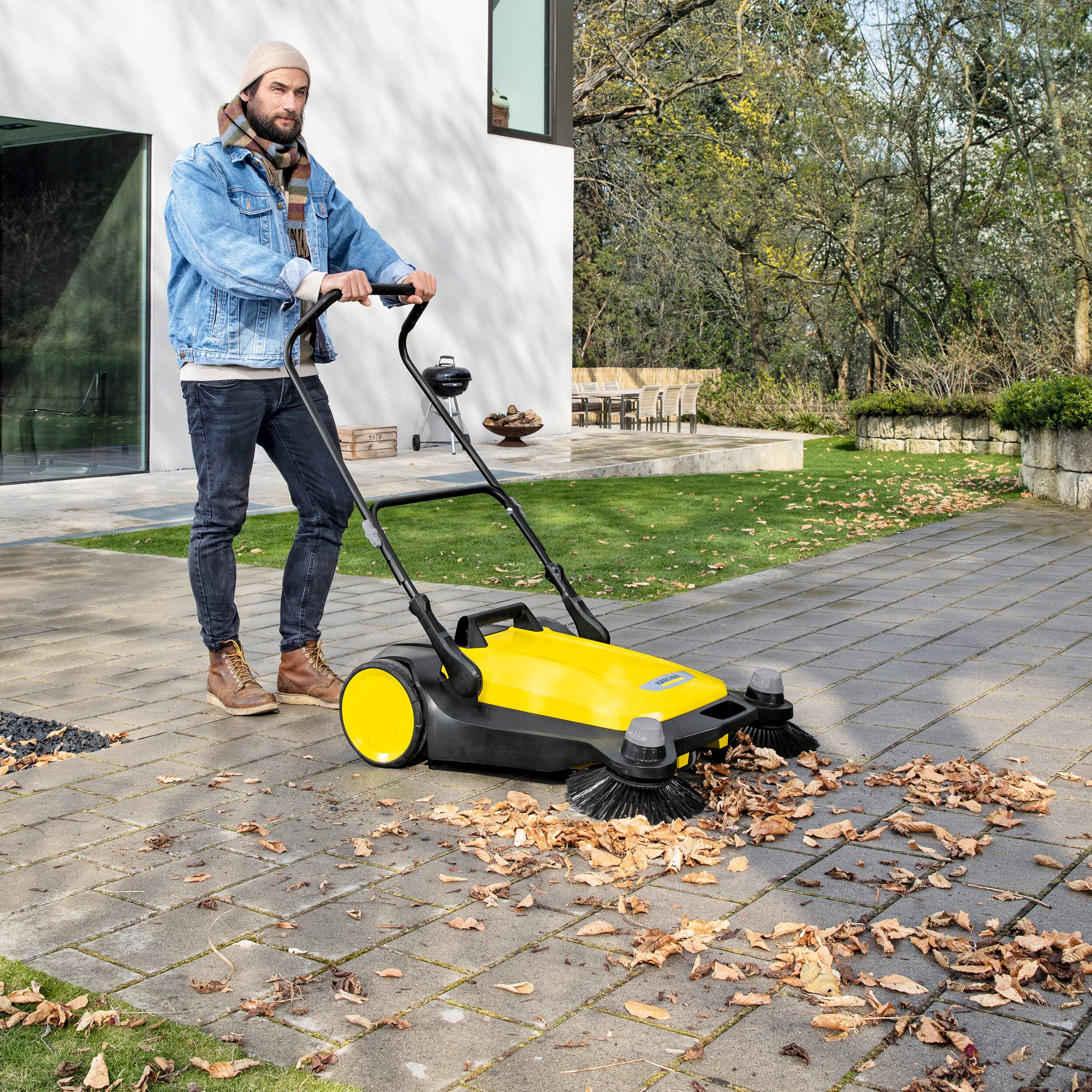 Left. Karcher - S 6 Twin Outdoor Push Sweeper, 10 Gallon, Walk-Behind Street Sweeper.