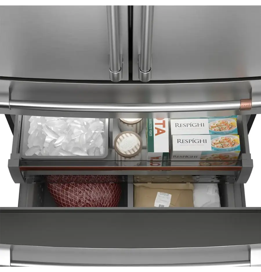 The image shows a refrigerator with its door open, revealing a drawer filled with various food items. The drawer contains several bottles, a bowl, and a package of meat. The bottles are placed in different positions within the drawer, with some standing upright and others lying horizontally. The bowl is located towards the center of the drawer, while the package of meat is placed towards the bottom right corner. The refrigerator is filled with food, making it a well-stocked and convenient appliance for meal preparation.